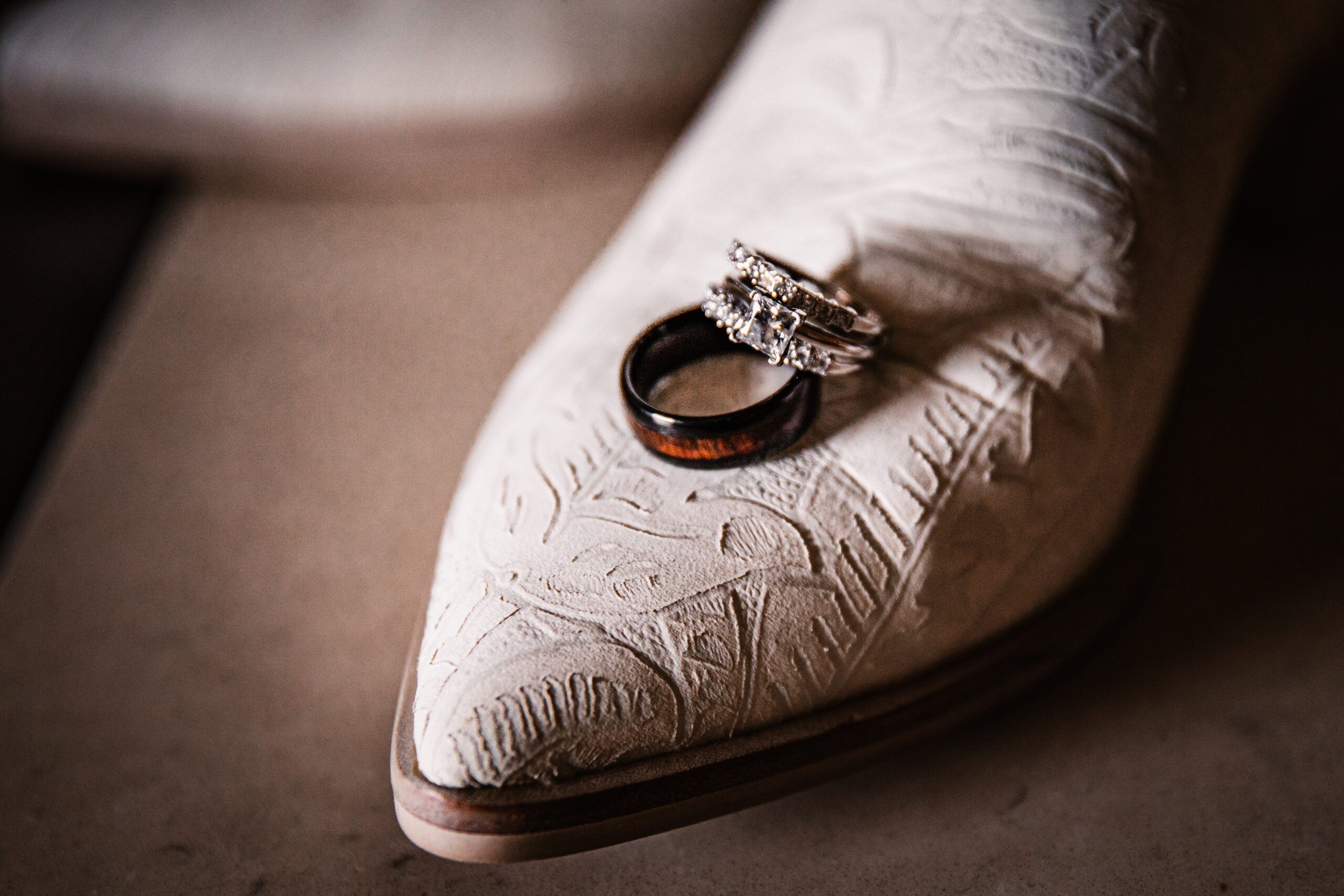 wedding rings on top of a boot