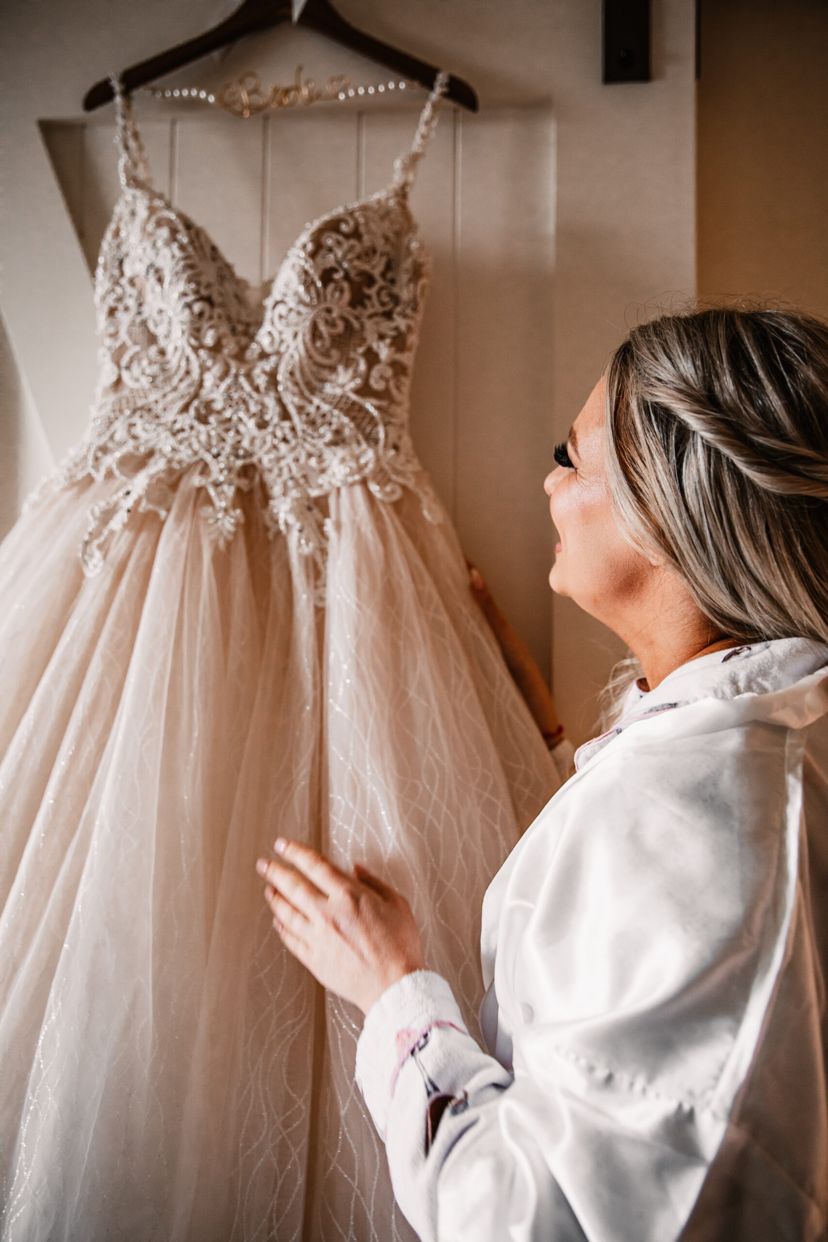 bride looking at her wedding dress