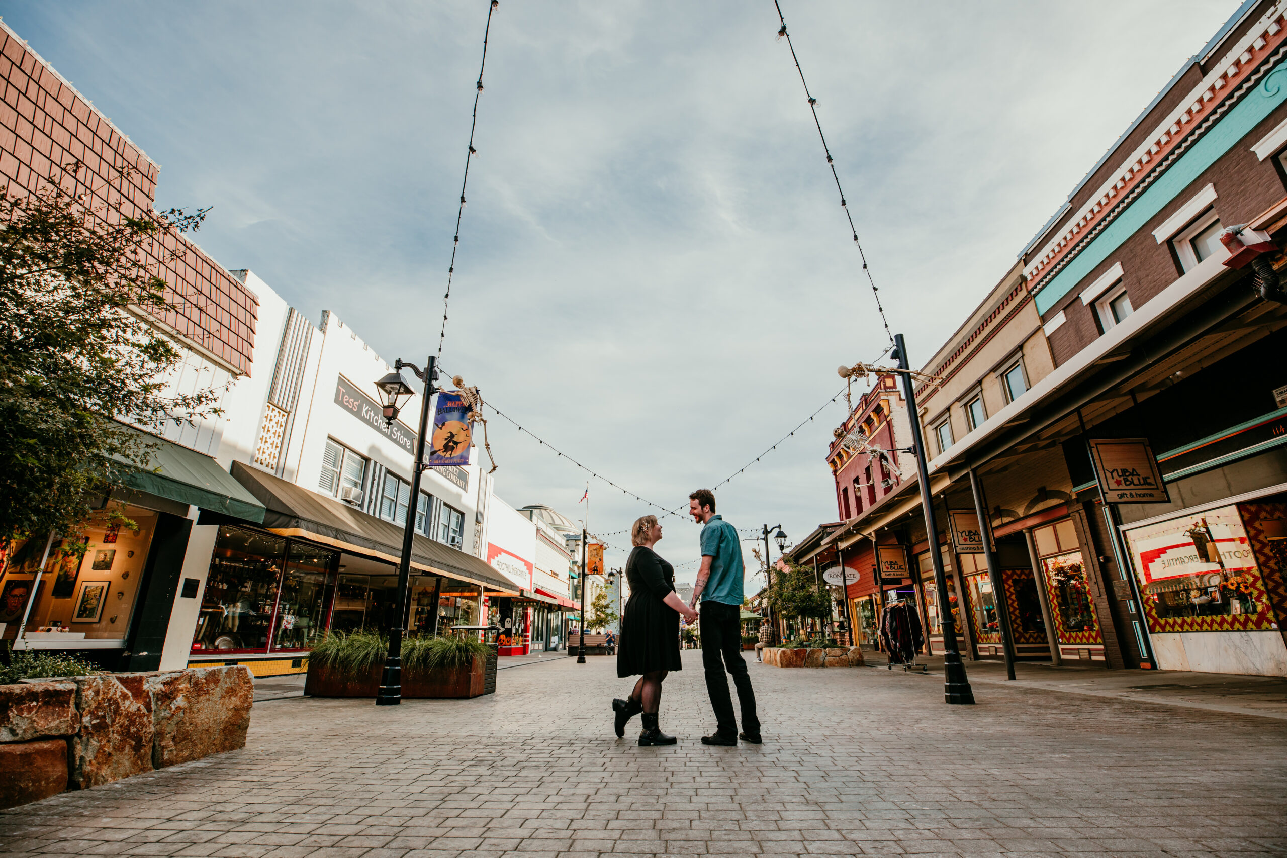Couple holding hands in the heart of historic downtown Grass Valley, California, during their Northern California elopement.
