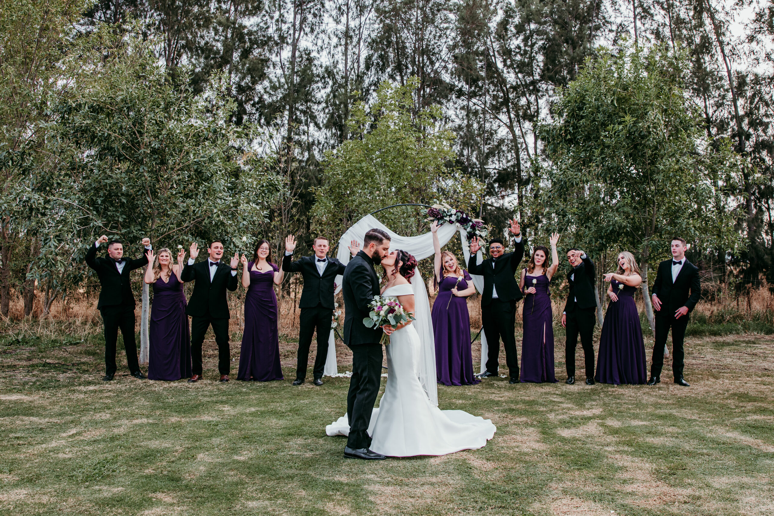 Bride and groom celebrating with their wedding party after the ceremony in a backyard fall wedding in Vacaville, CA