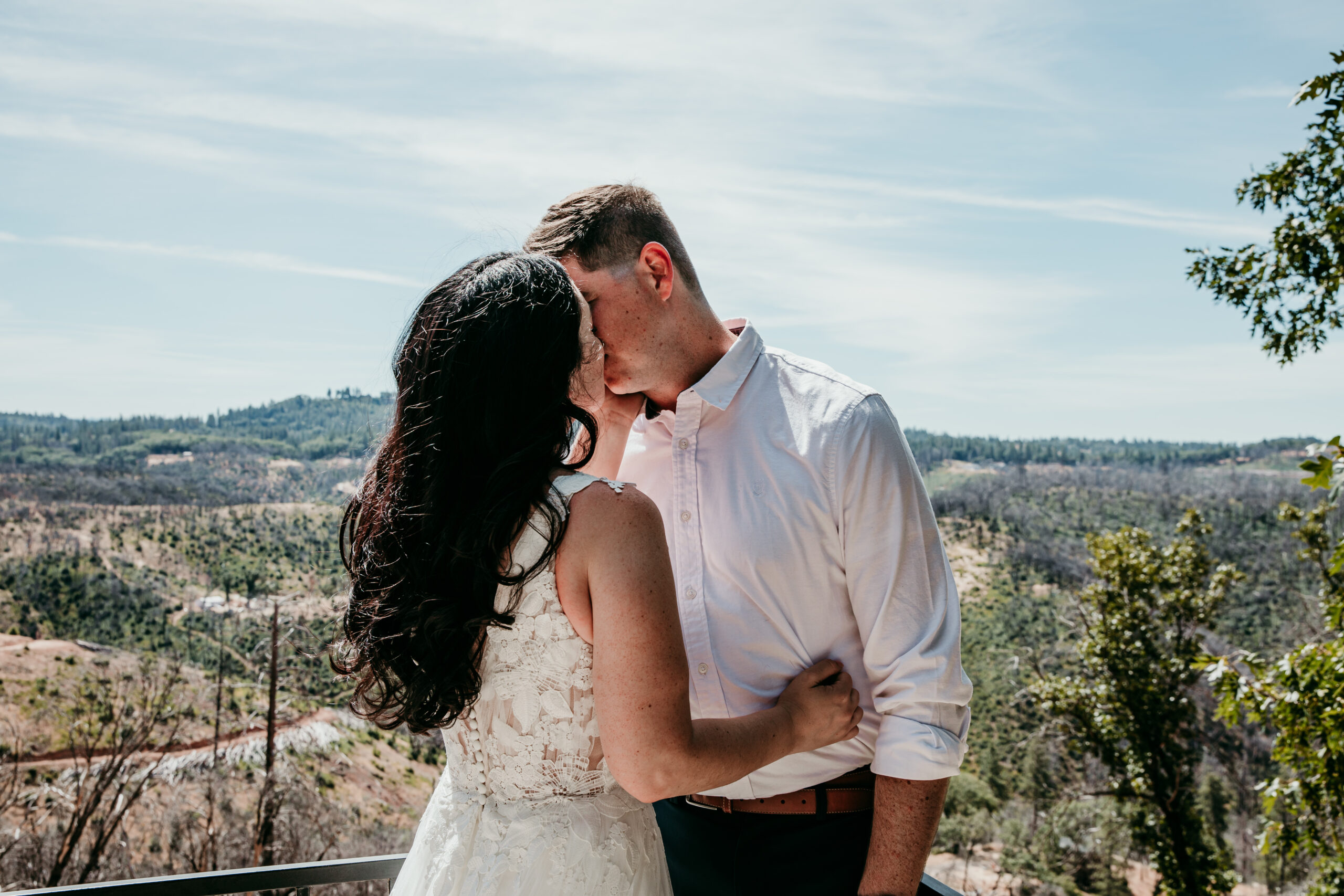 Bride and groom share an intimate kiss on their Airbnb deck during their Northern California elopement.