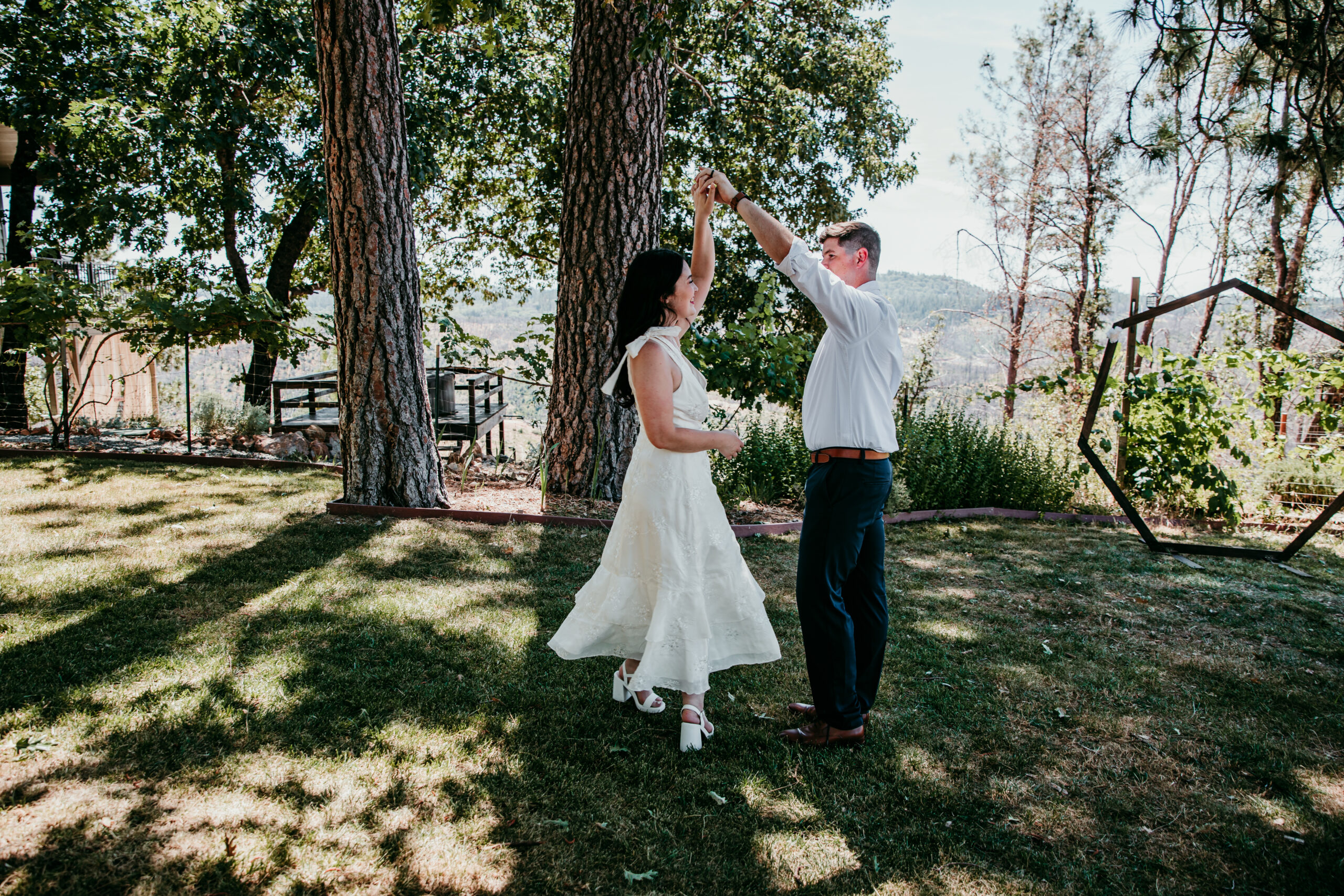 Groom twirls the bride in celebration during their relaxed Northern California Airbnb elopement.