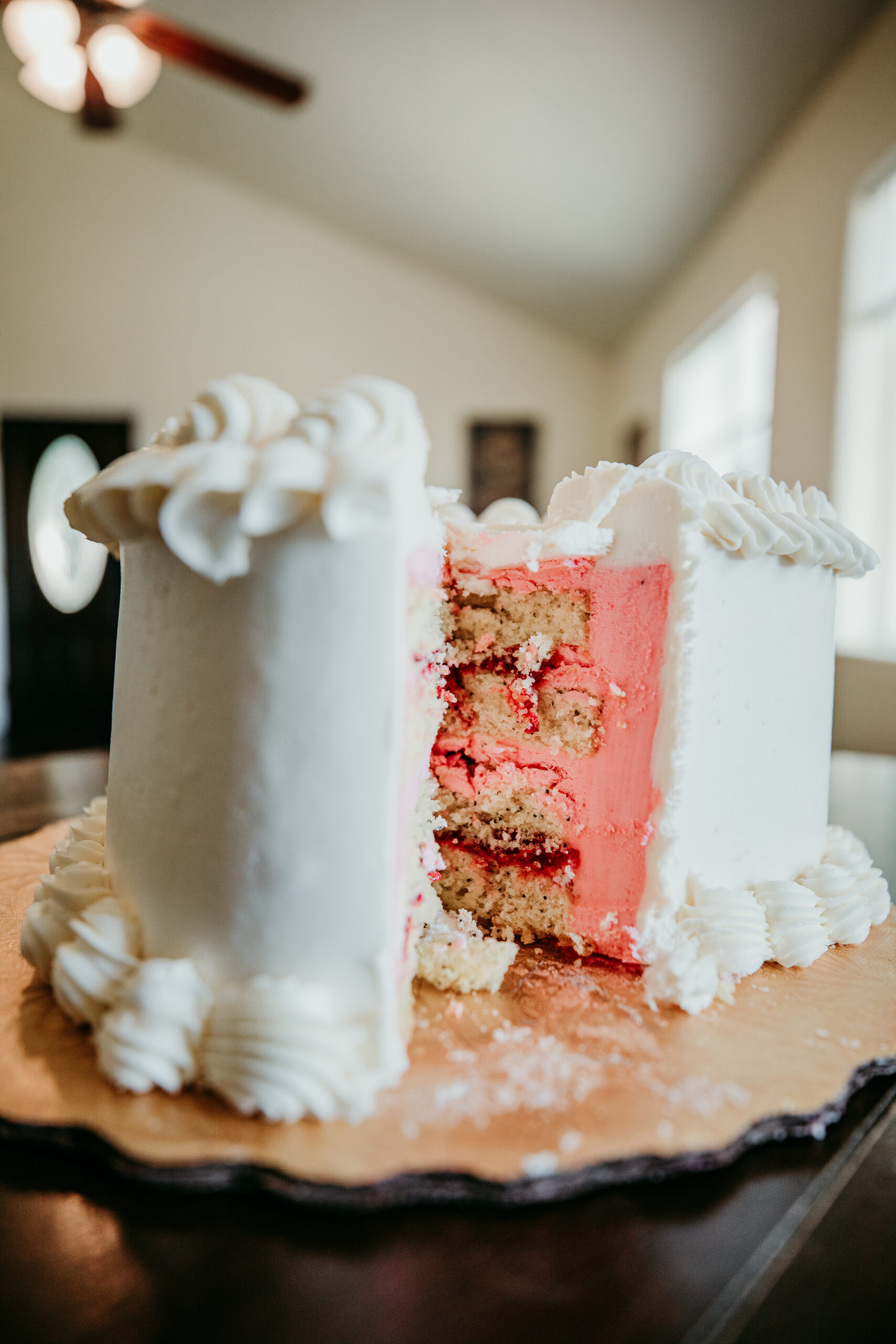 Close-up of the couple’s wedding cake with a surprise pink center at their Northern California elopement reception.