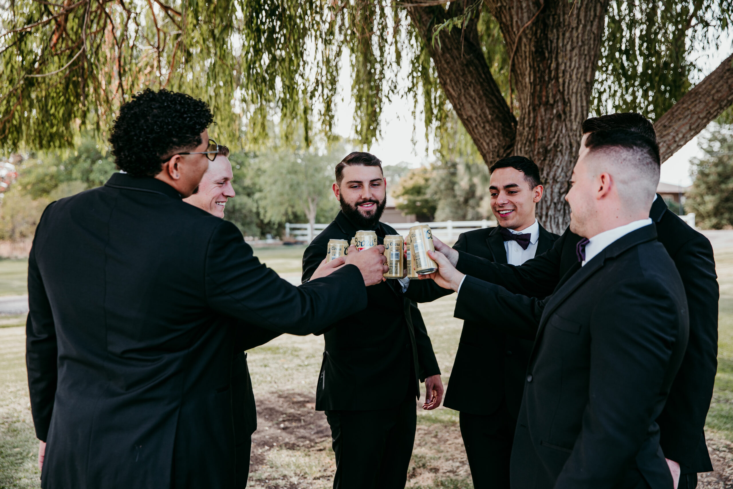 Groom and groomsmen cheers with drinks before the backyard wedding ceremony in Vacaville, CA