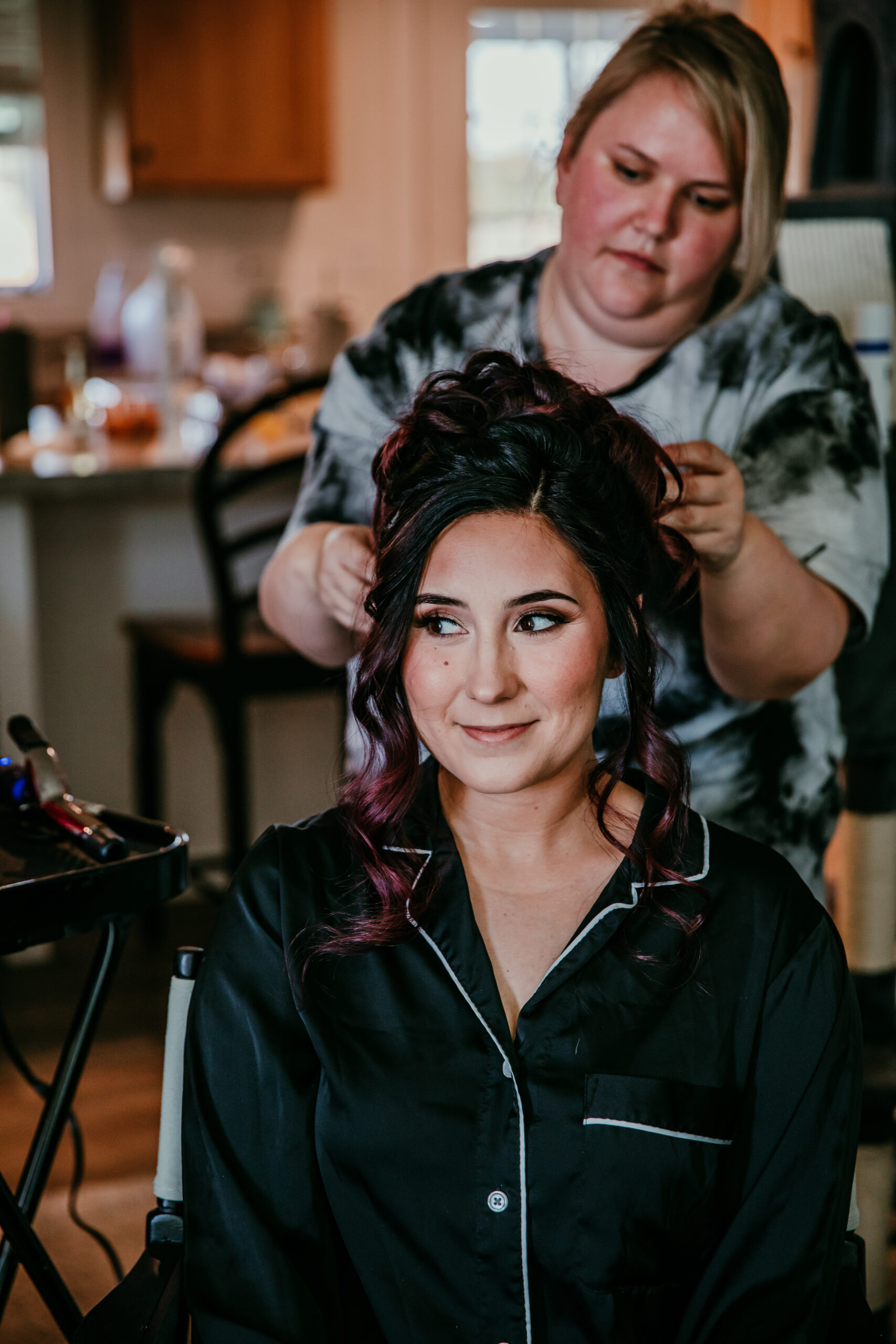 Bride getting her hair done on the morning of her fall wedding in Vacaville, captured by Bay Area wedding photographer