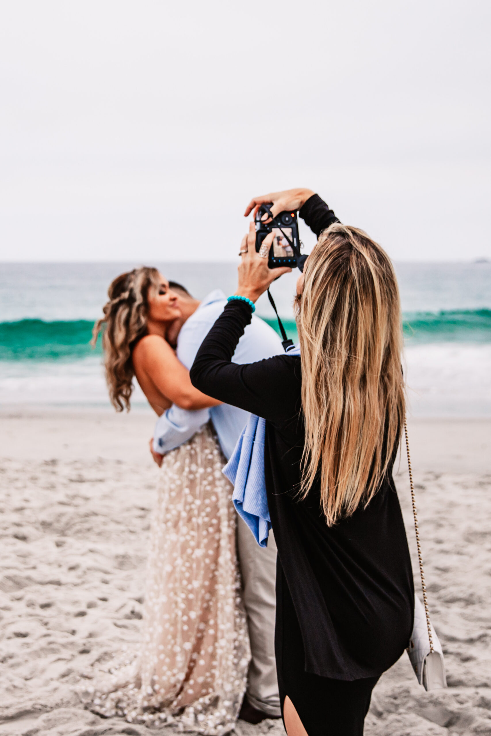 Elopement photographer capturing a joyful couple on a California beach, showing how to elope in California with a fun and relaxed coastal vibe.