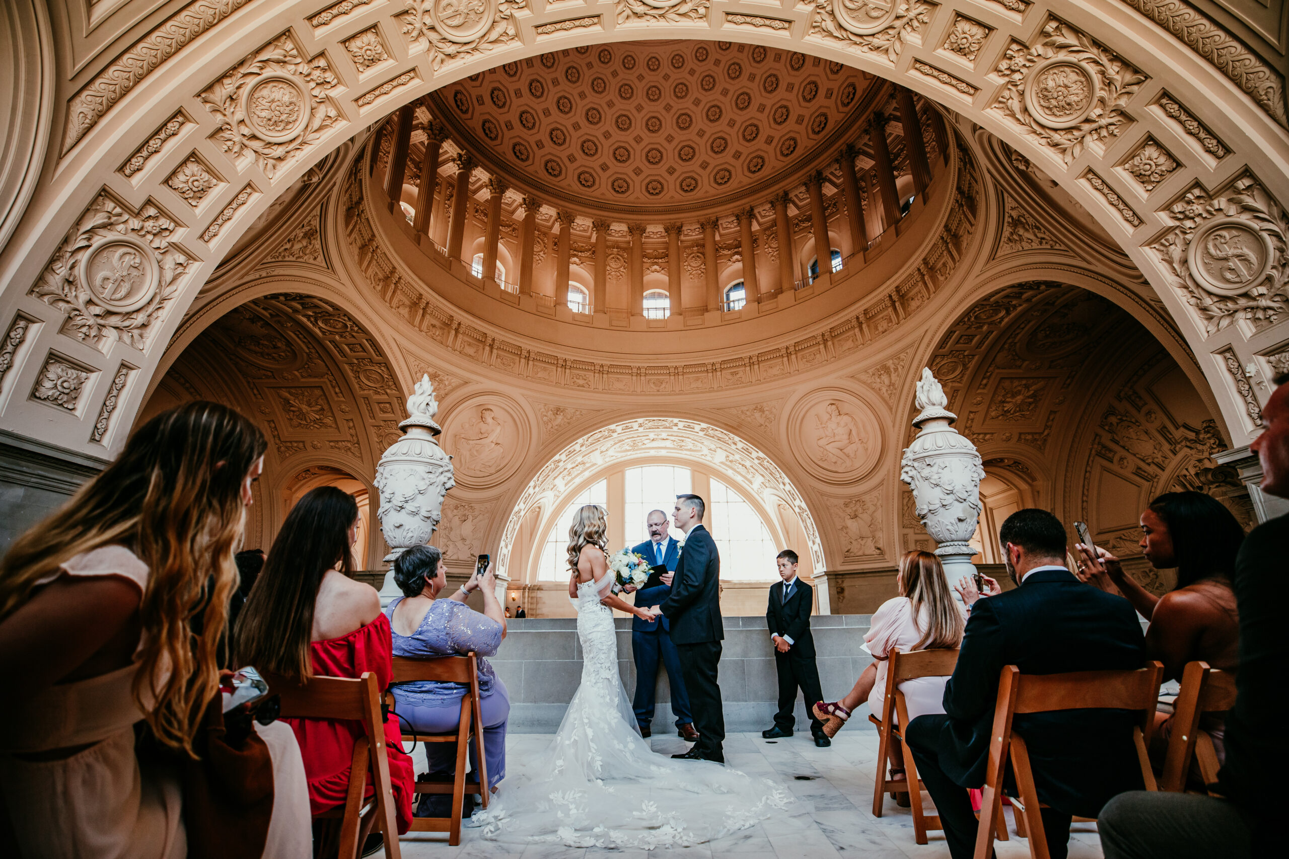 Indoor ceremony at San Francisco City Hall with friends and family, showing how to elope in California with an elegant and timeless city setting.