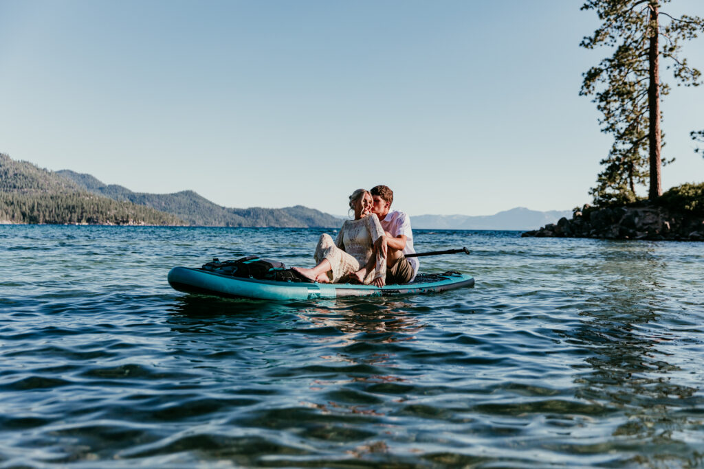 Couple paddleboarding together on an alpine lake during their Mount Shasta elopement, sharing a quiet moment on the water.