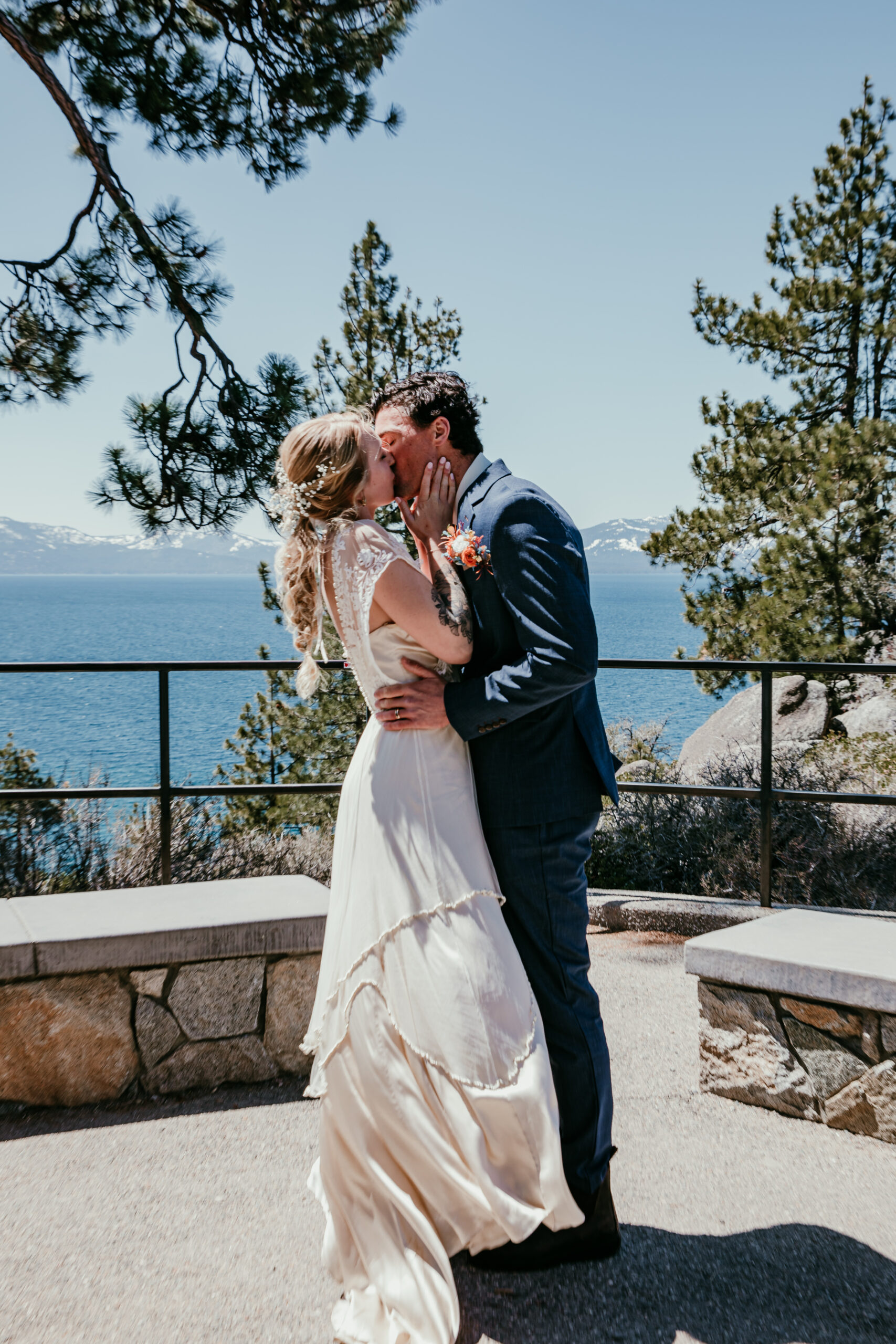 Bride and groom share their first kiss with a stunning lake backdrop at their Logan Shoals Vista Point elopement