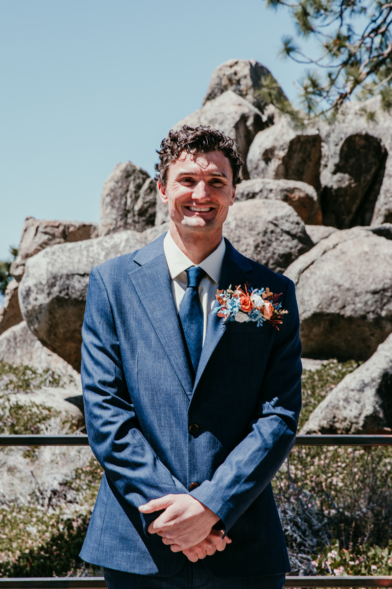 Groom smiling and waiting for the ceremony to begin during his Logan Shoals Vista Point elopement