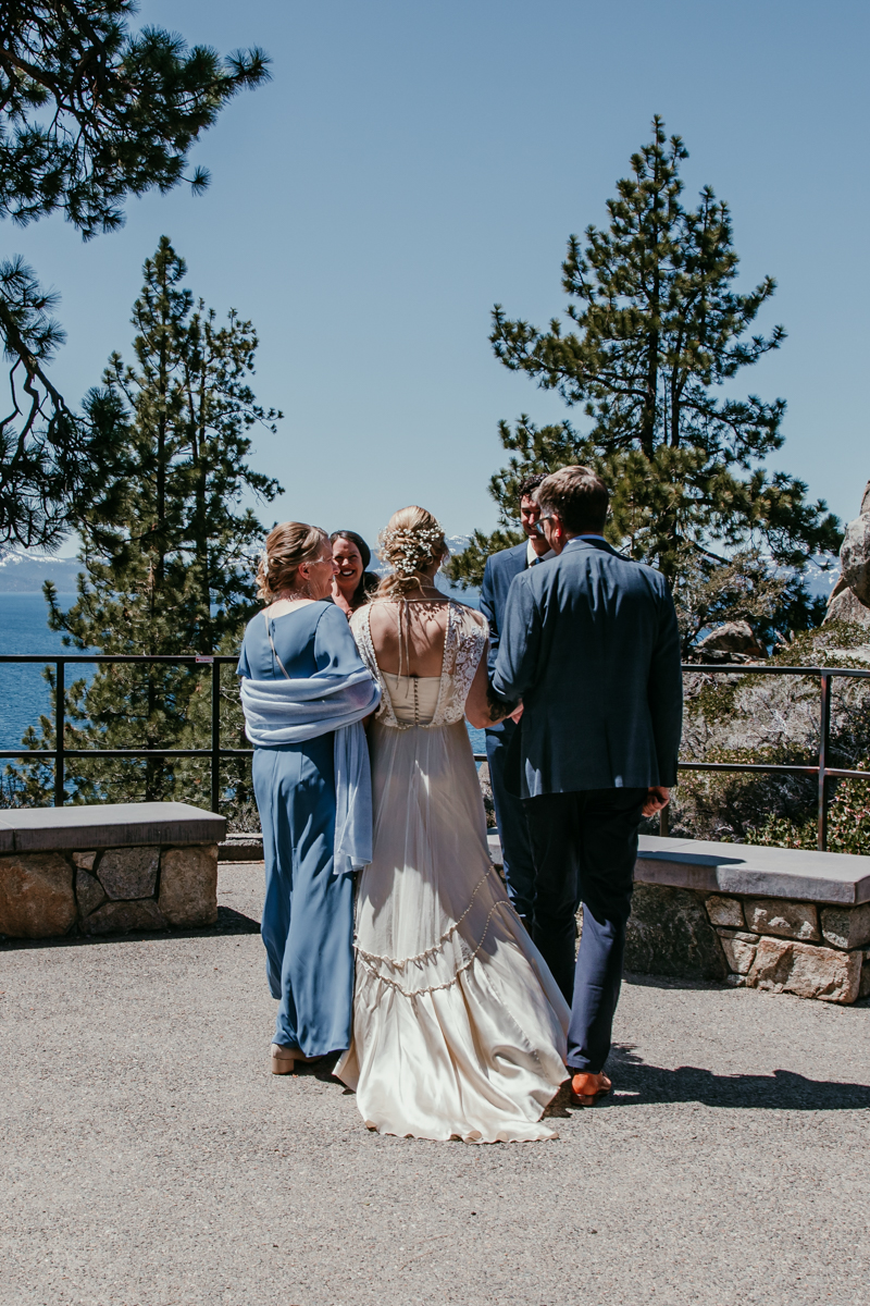 Bride and her parents walking into the ceremony space overlooking the lake at their Logan Shoals Vista Point elopement