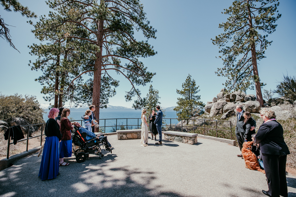 Couple exchanging vows surrounded by family during their Logan Shoals Vista Point elopement overlooking Lake Tahoe