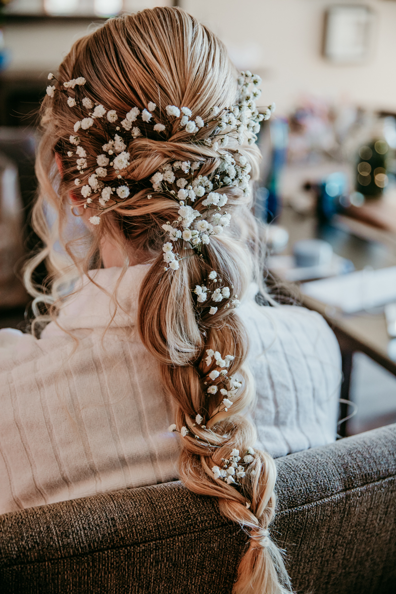 Bride’s boho braided hairstyle with baby’s breath florals woven throughout. hair by lea bgorgeous