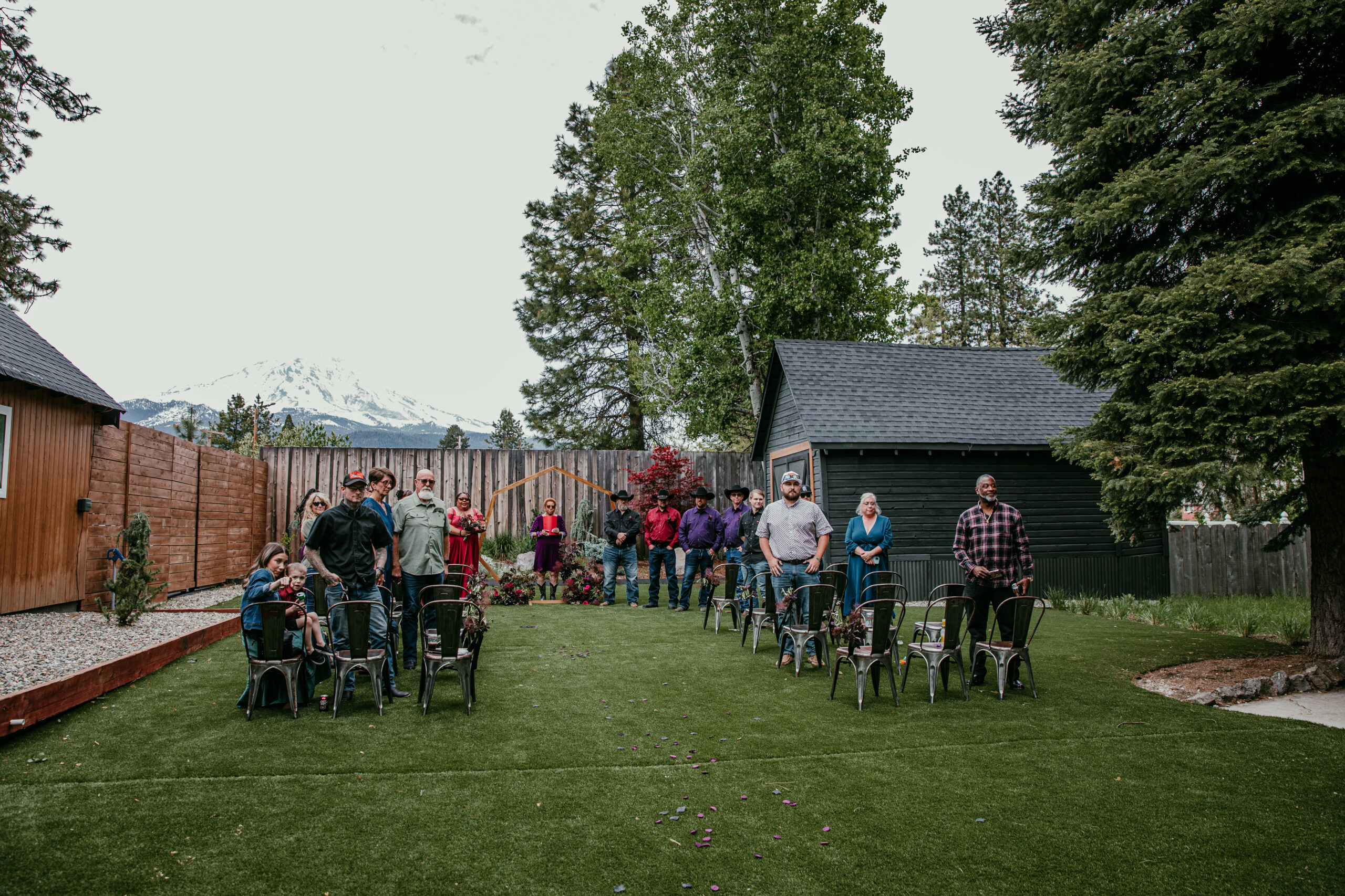 Guests standing and watching the ceremony at Shasta View Lodge with Mount Shasta in the background while a couple is eloping in Mount Shasta.