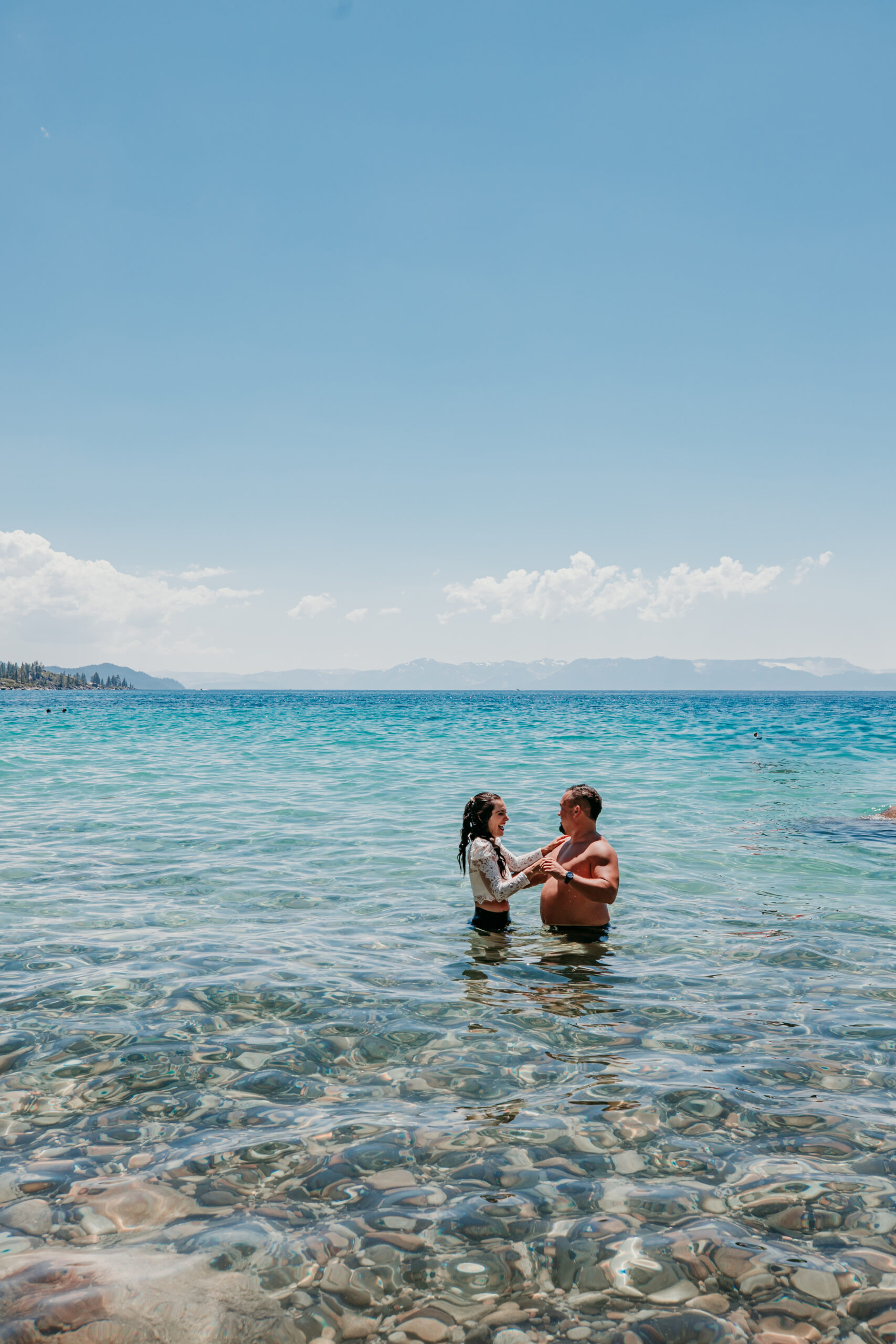 Bride and groom standing in the shallow water of Lake Tahoe during their elopement.