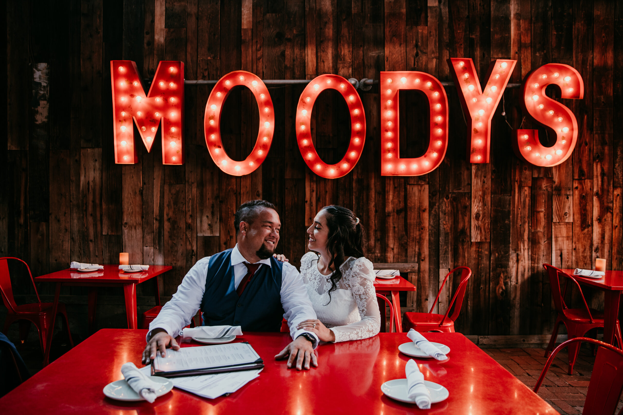 Bride and groom smiling at each other while dining at Moody’s Bistro during their elopement in Lake Tahoe.