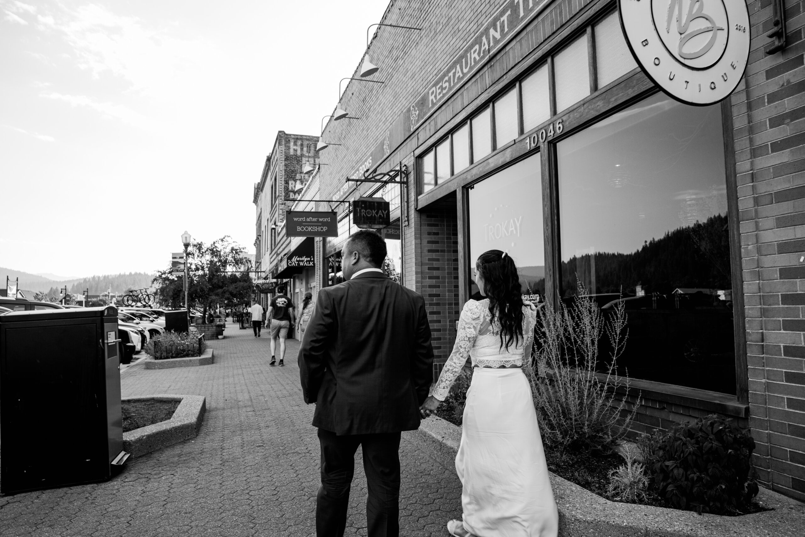 Bride and groom walking hand-in-hand through downtown Truckee after their elopement in Lake Tahoe.