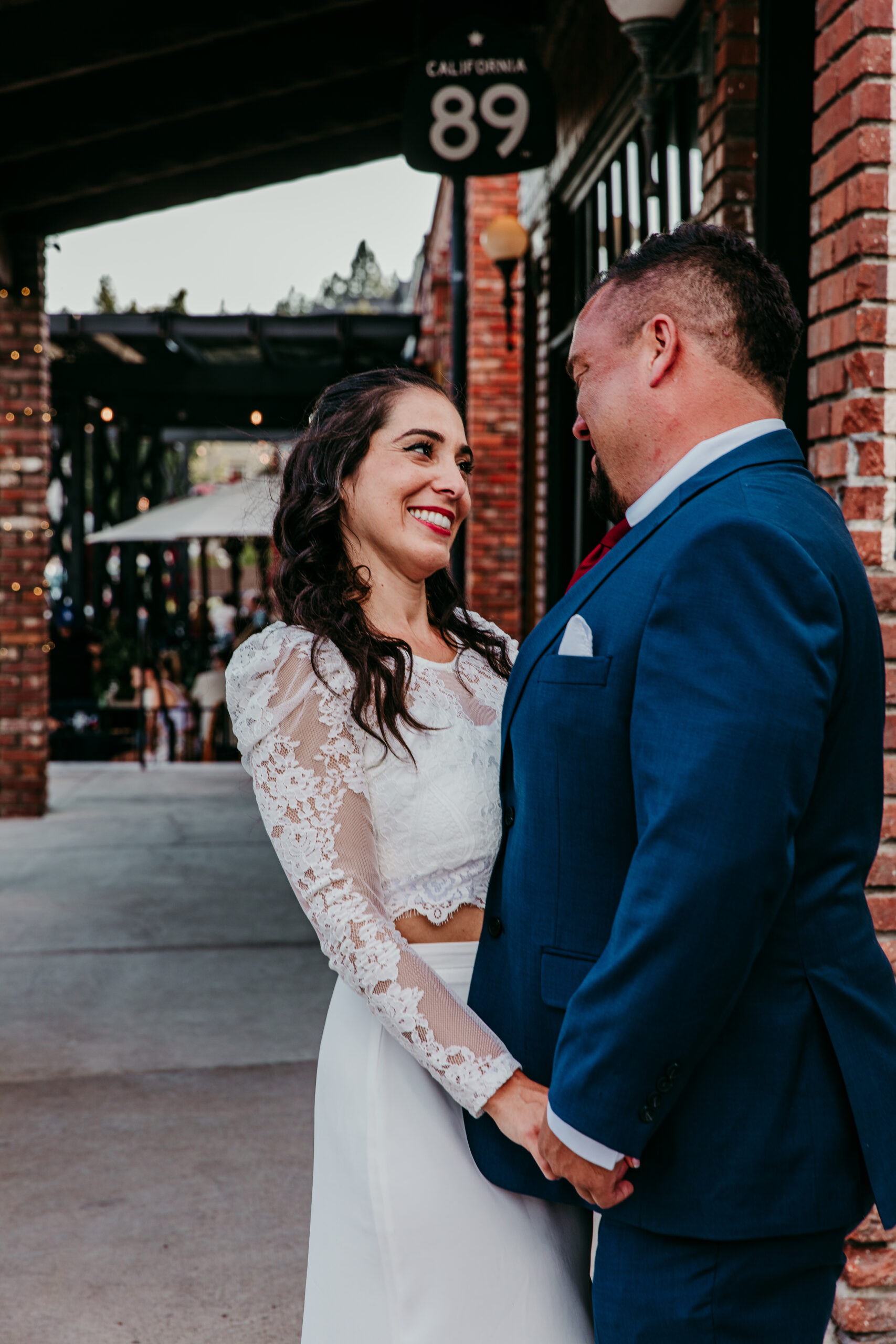 Bride and groom smiling at each other in downtown Truckee during their Lake Tahoe elopement