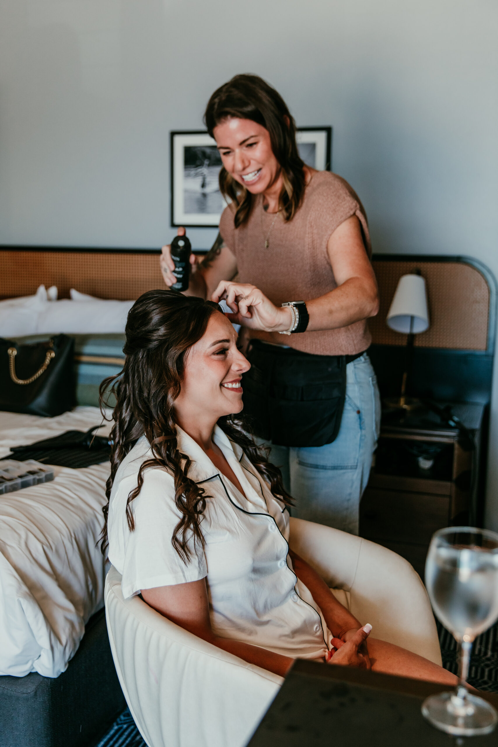 Bride getting her hair styled and smiling during the getting-ready moments before eloping then having a wedding celebration in Lake Tahoe.