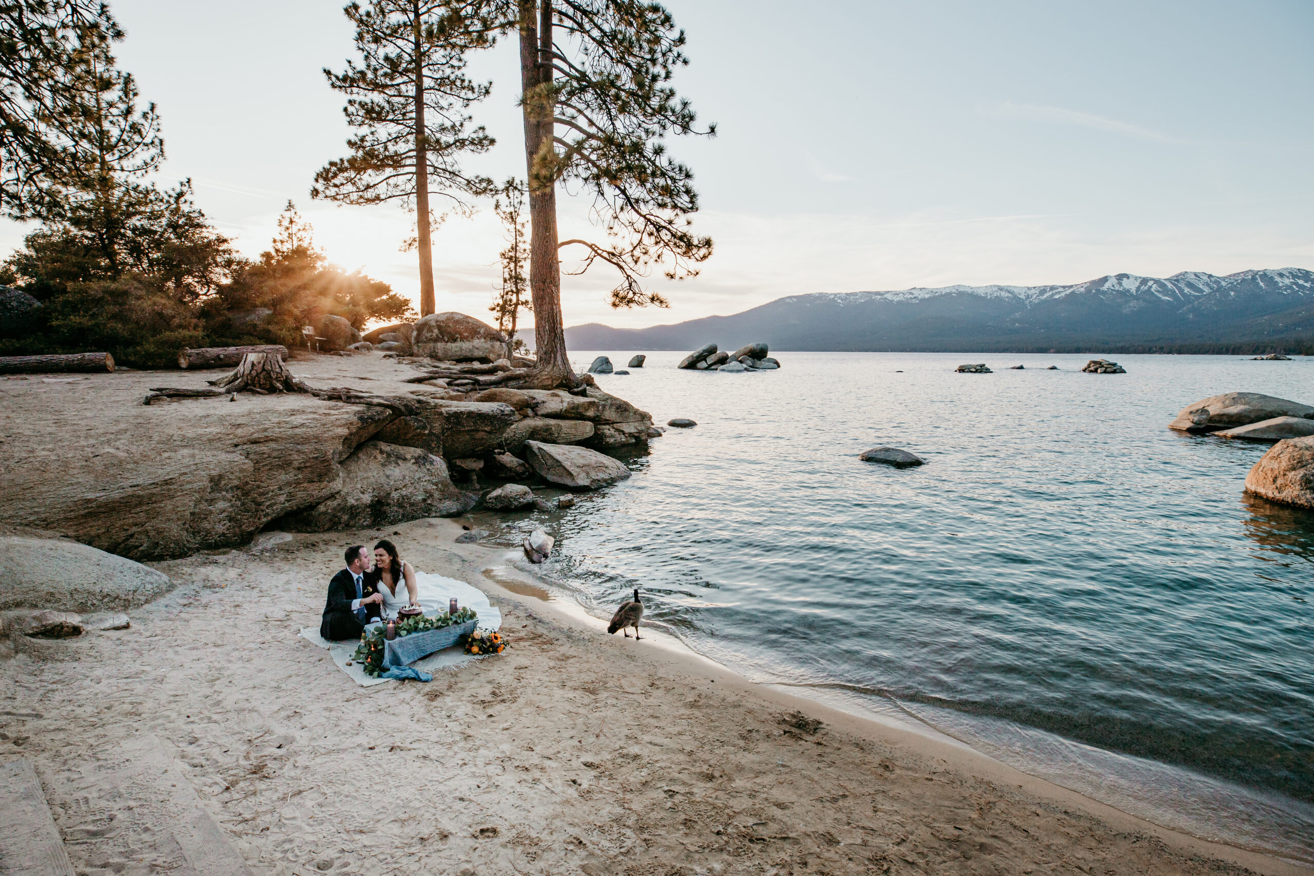 Couple sharing a toast during their lake tahoe sunset elopement at Sand Harbor, Lake Tahoe.
