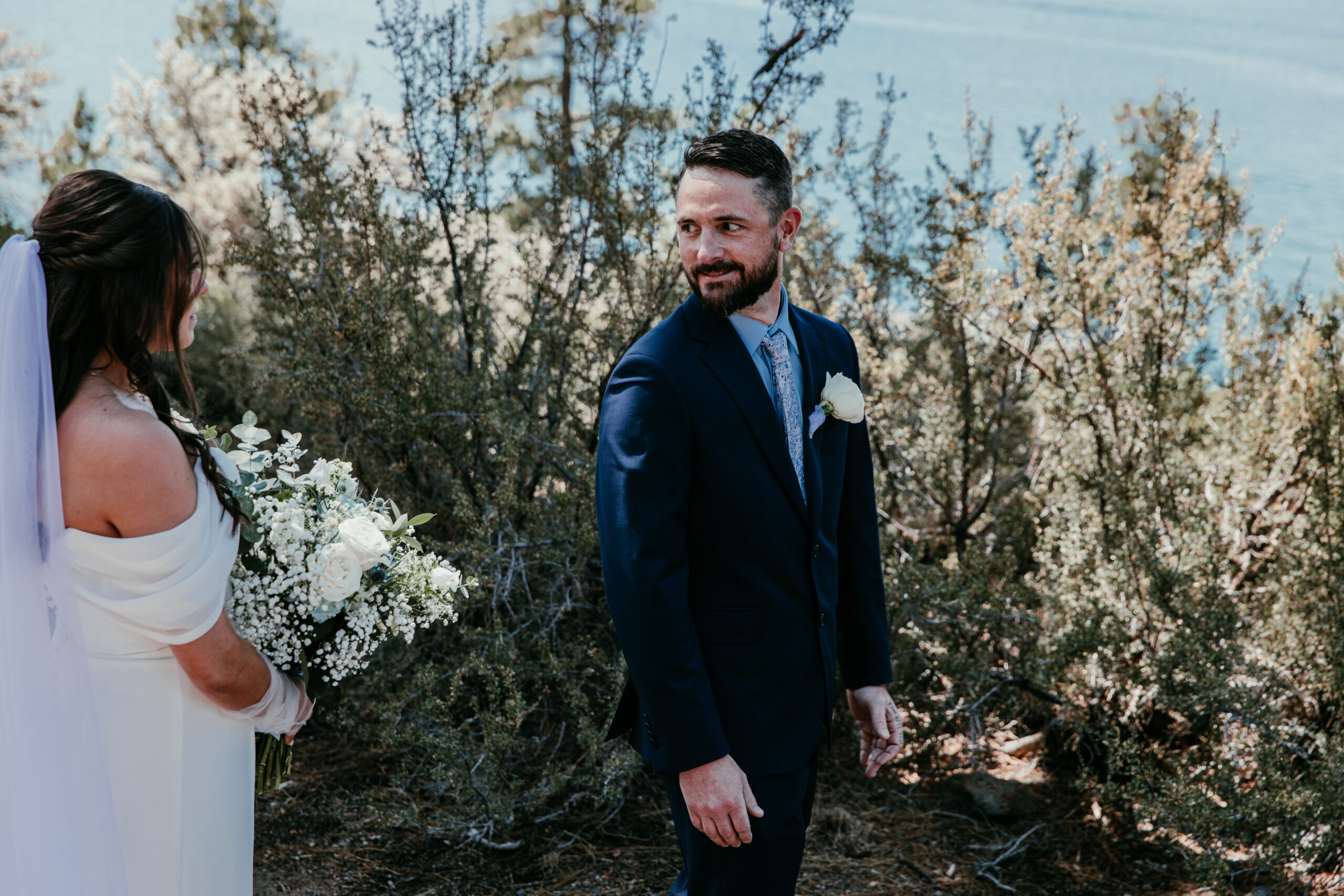 Groom seeing his bride for the first time during their elopement Lake Tahoe first look.