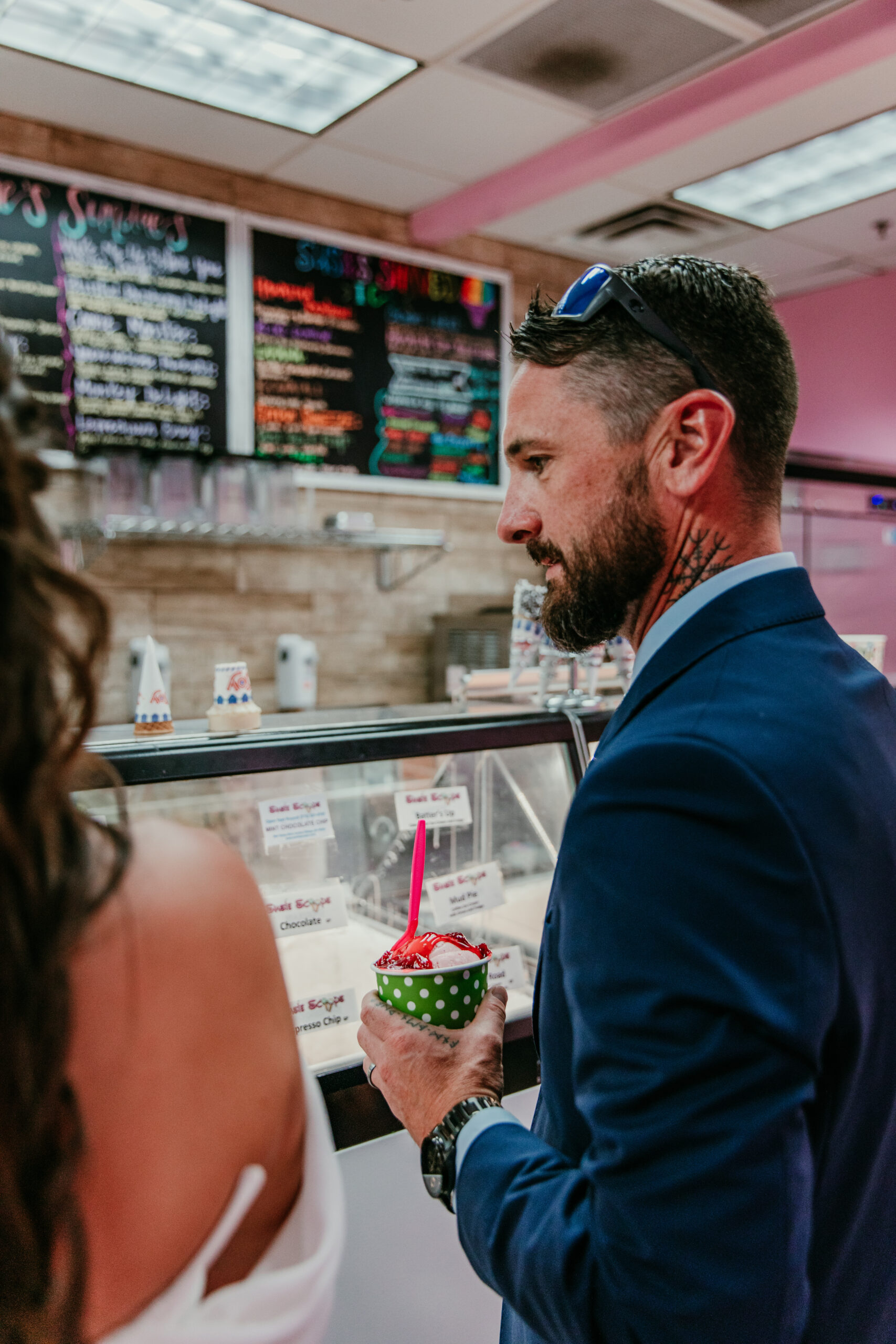 Groom holding a cup of ice cream inside Susie Scoops during their elopement Lake Tahoe.