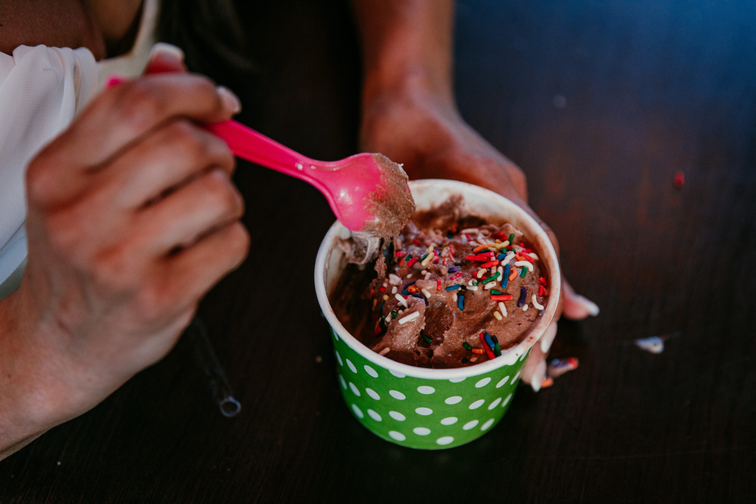 Close-up of bride’s chocolate ice cream with sprinkles during their elopement Lake Tahoe treat stop.