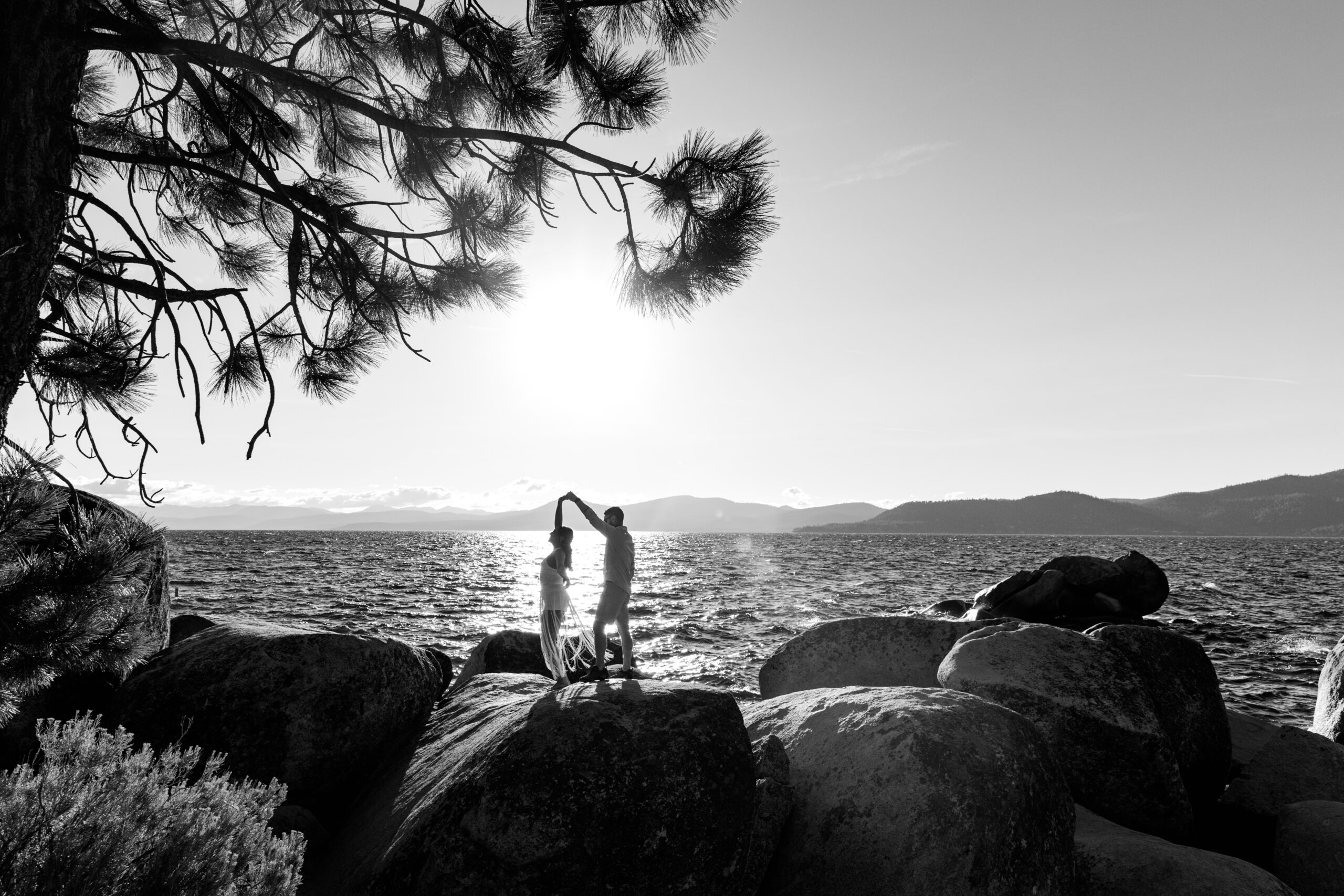 Couple dancing on the rocks at Sand Harbor during a sunset elopement Lake Tahoe.