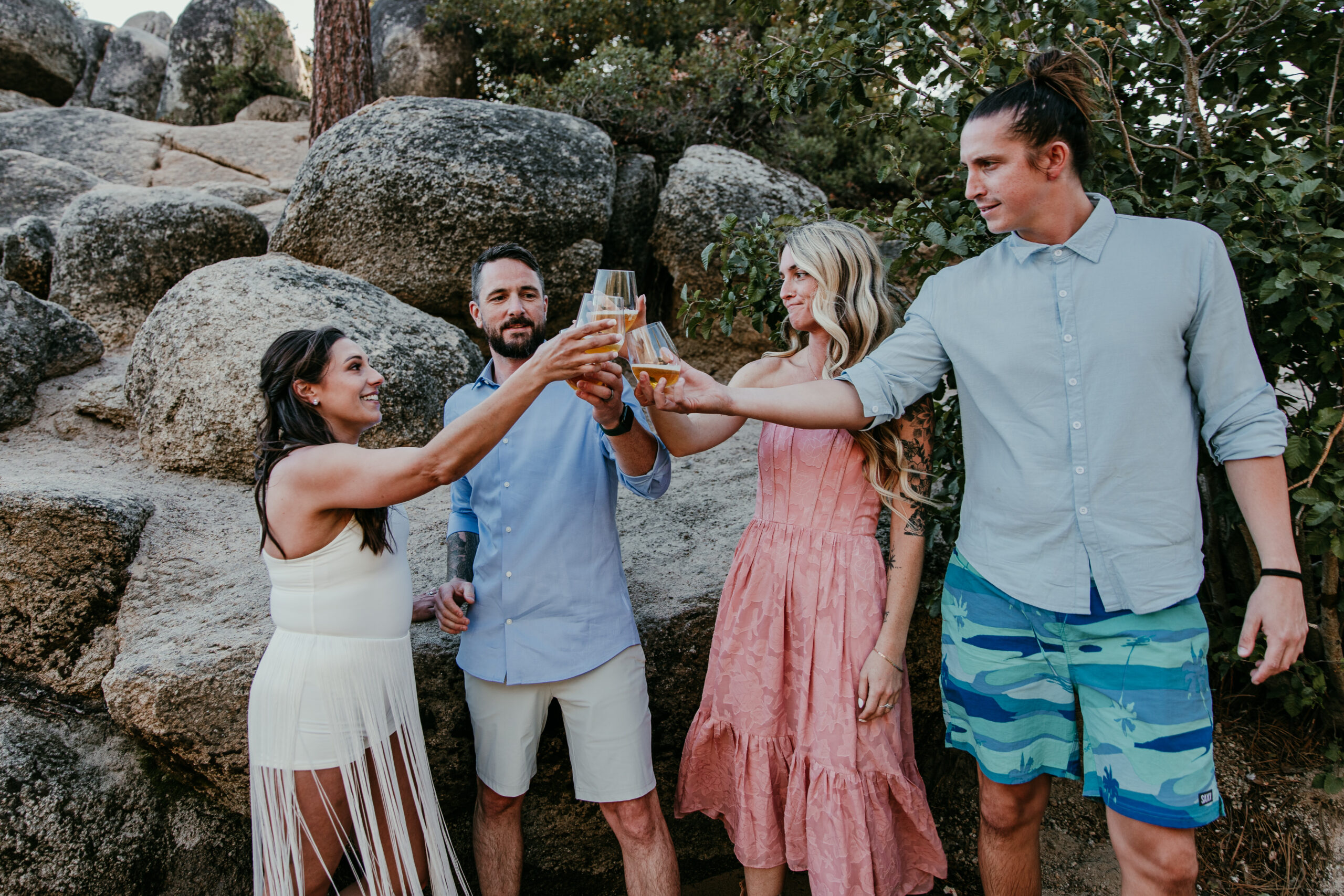 Bride and groom toasting with friends at Sand Harbor during their elopement Lake Tahoe.