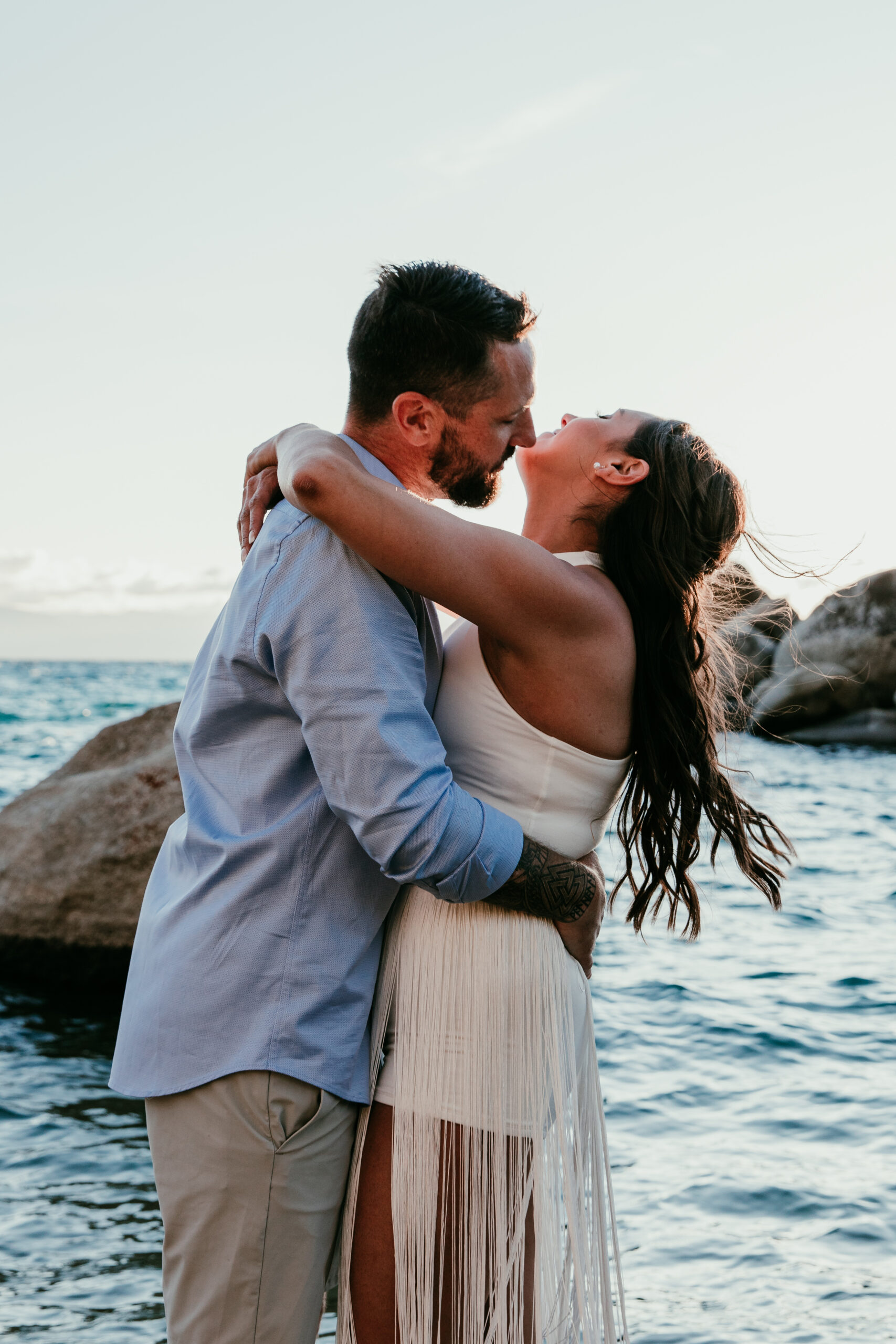 Couple kissing by the water at Sand Harbor during their romantic elopement Lake Tahoe.