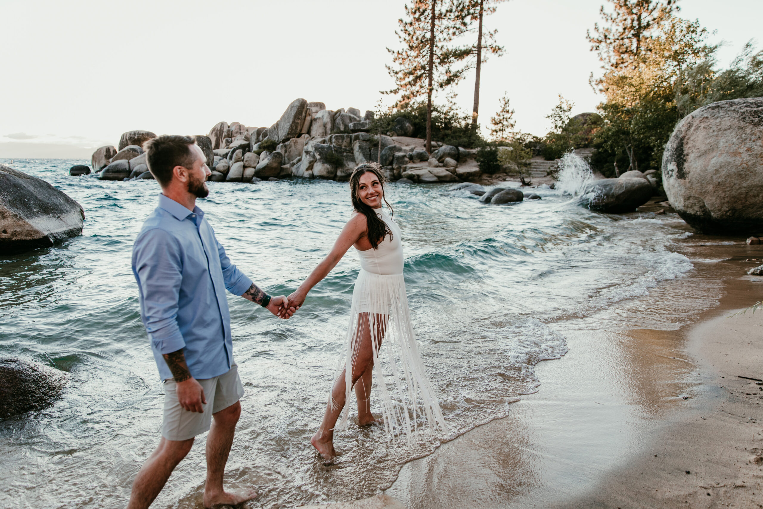 Bride leading groom along the shoreline at Sand Harbor during their elopement Lake Tahoe.