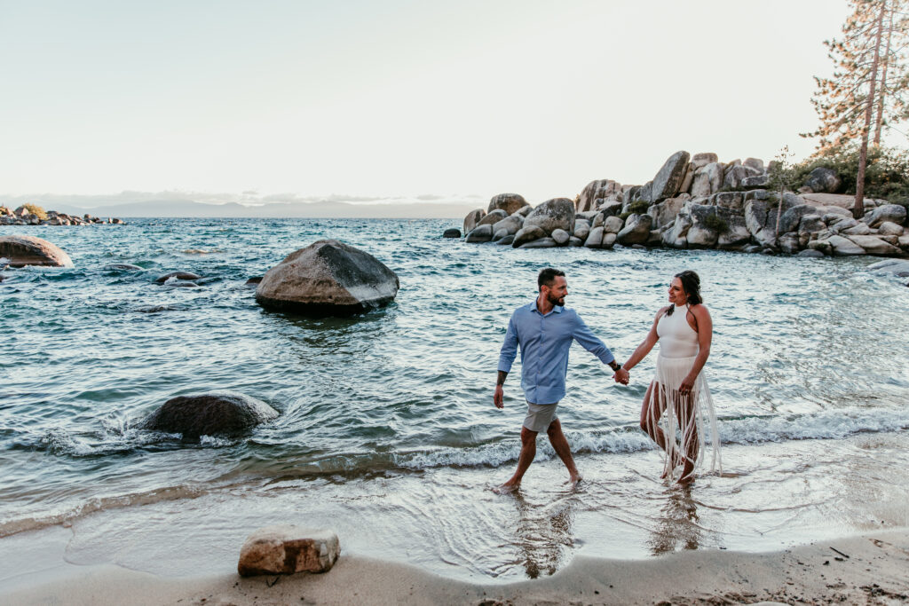 Couple walking along the shoreline after their ceremony showing relaxed elopement ideas in California