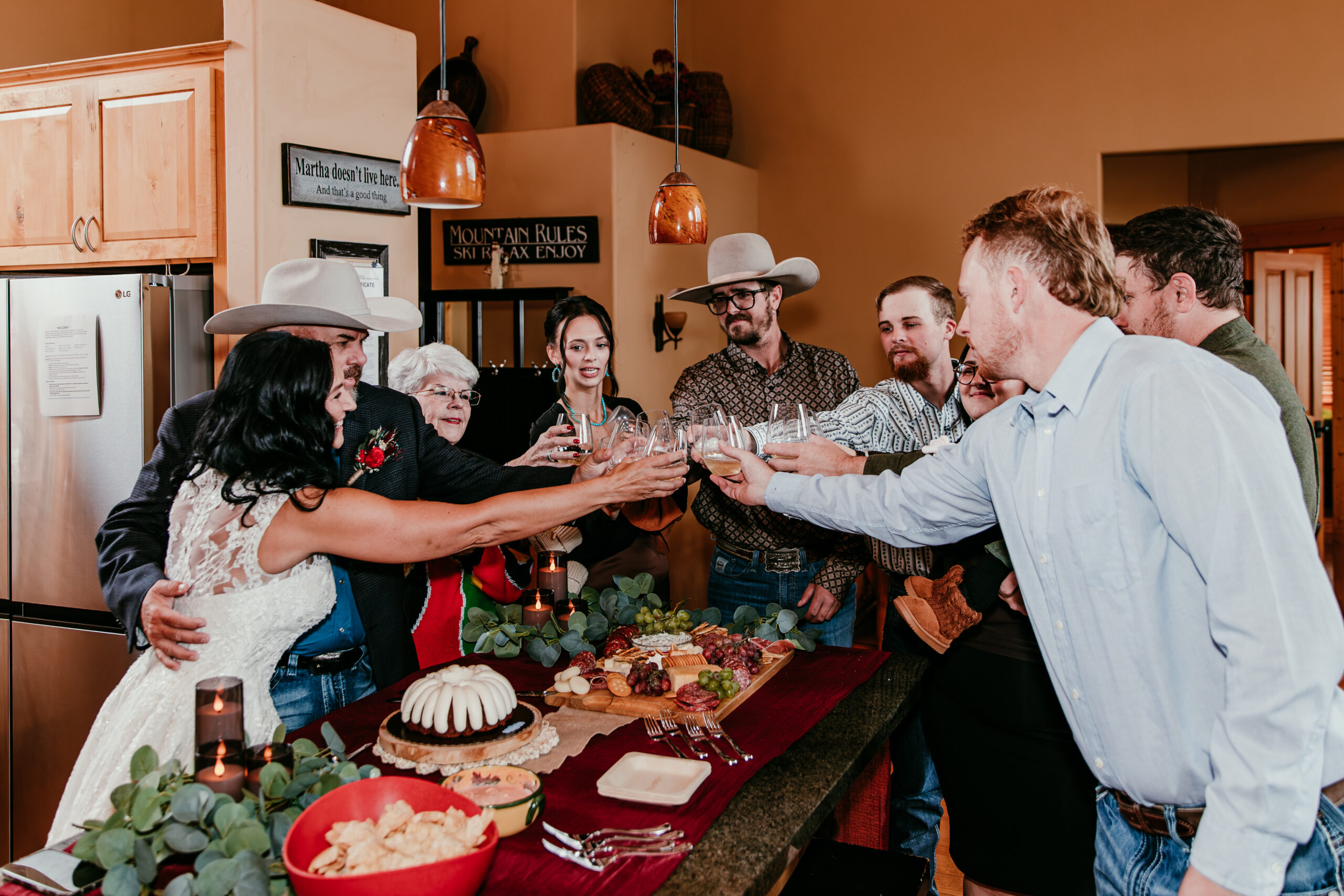 Family and friends raising glasses during an intimate celebration following a Lake Tahoe elopement, captured in joyful lake tahoe elopement photos inside a cozy cabin
