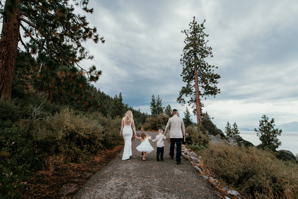 Blended family walking hand in hand after Lake Tahoe elopement ceremony at Logan Shoals