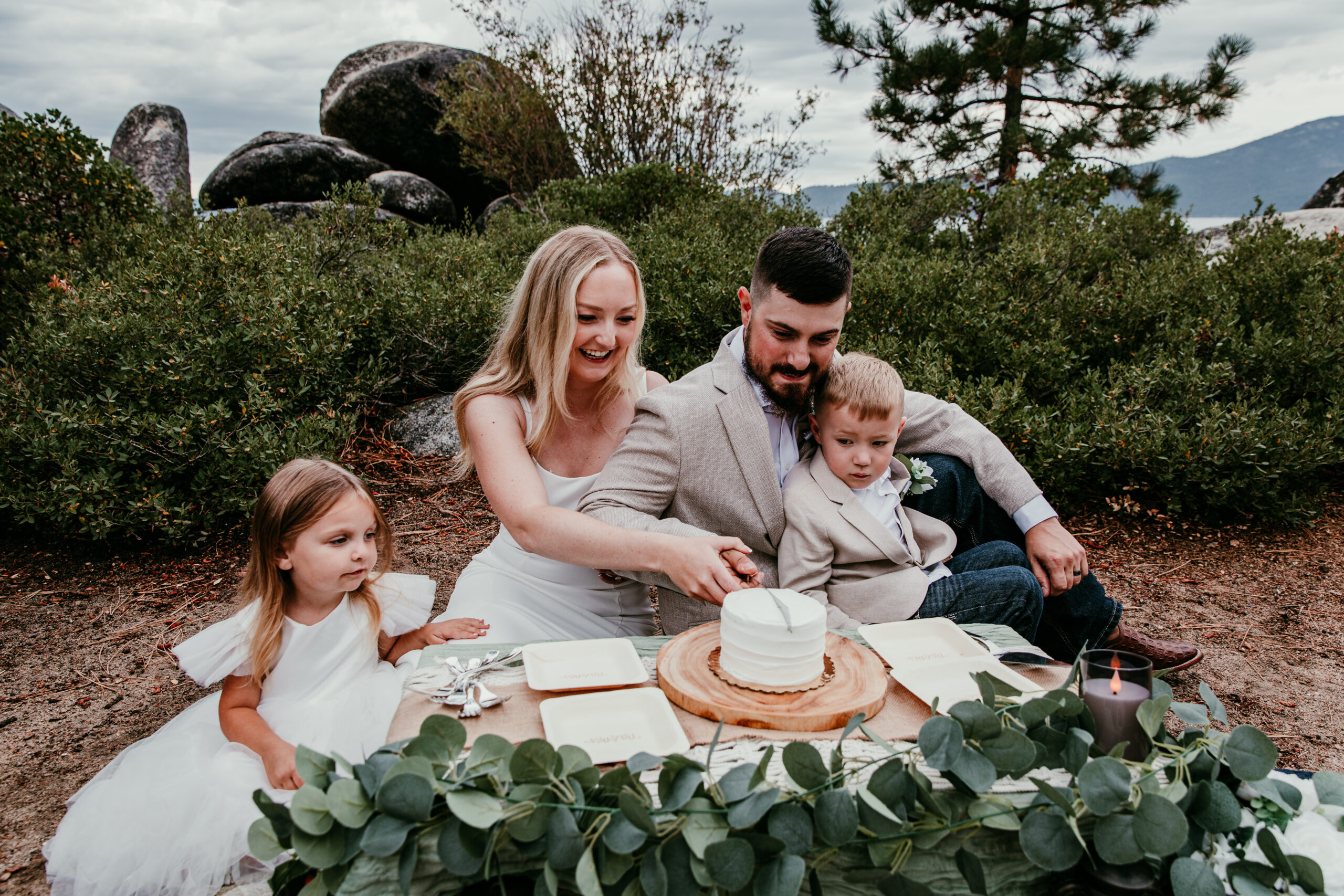 Small wedding with kids celebrating together at picnic setup, family-focused and intimate moment