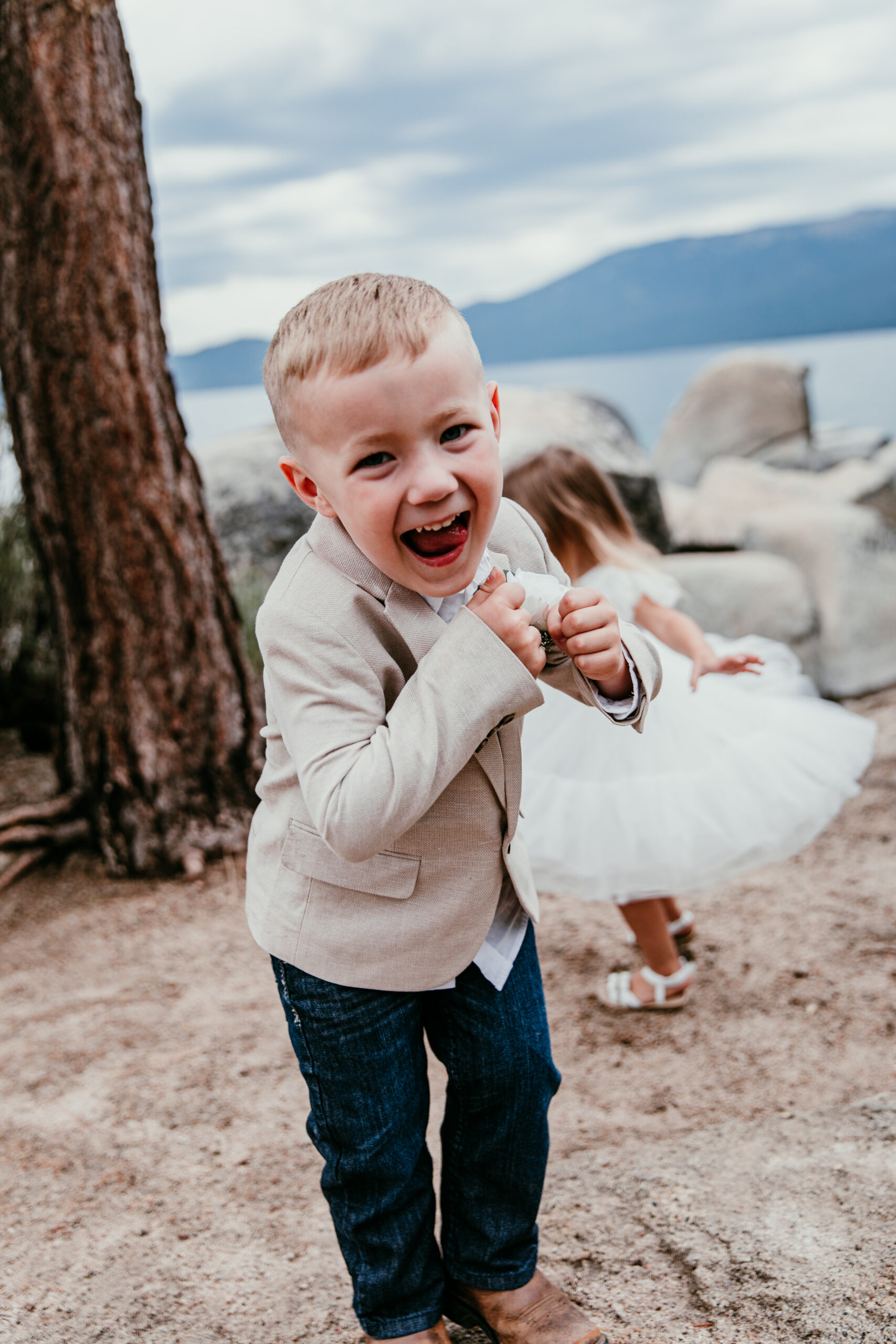 Young boy laughing at Sand Harbor during Lake Tahoe elopement with kids