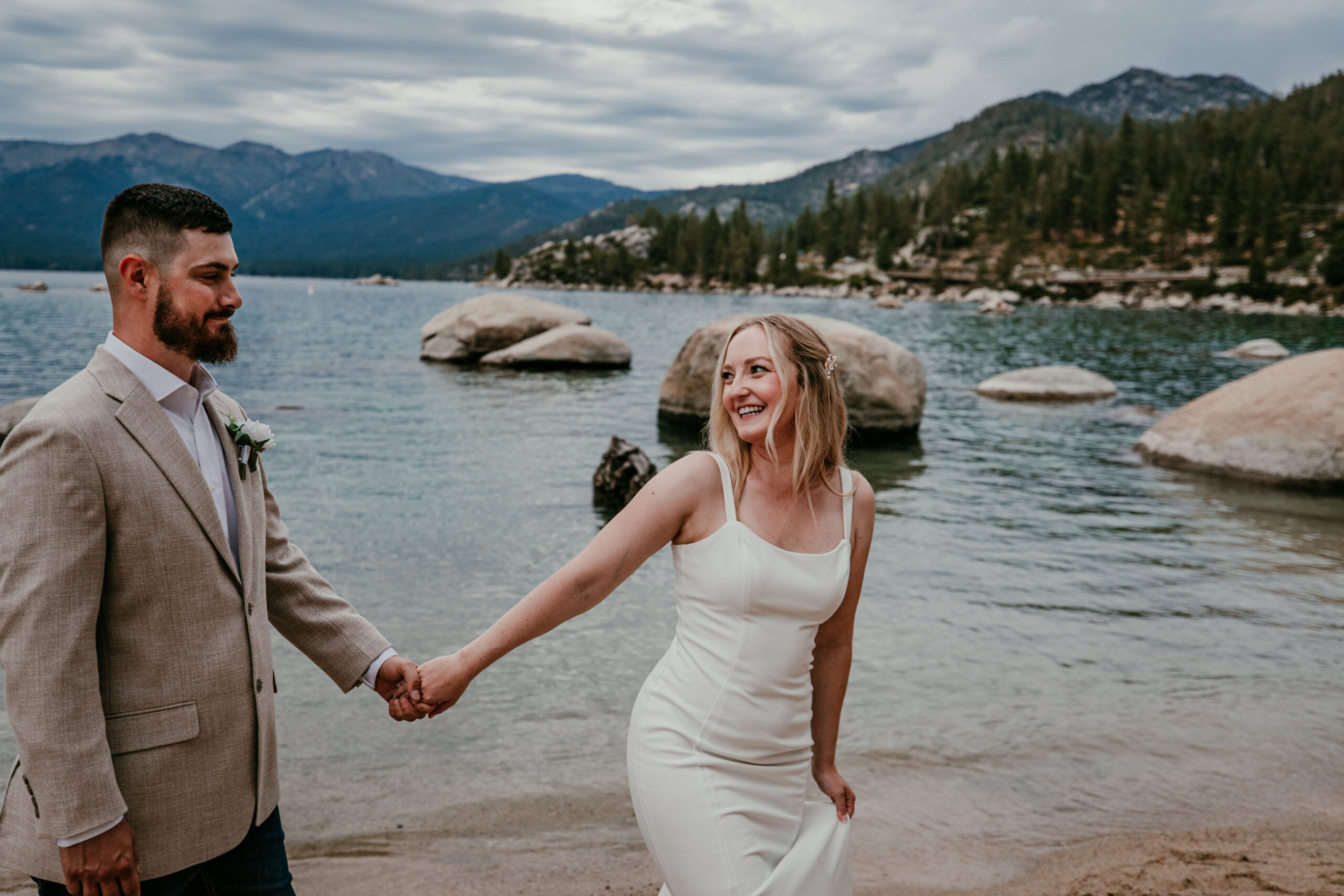Couple walking hand in hand at Sand Harbor during Lake Tahoe elopement at sunset