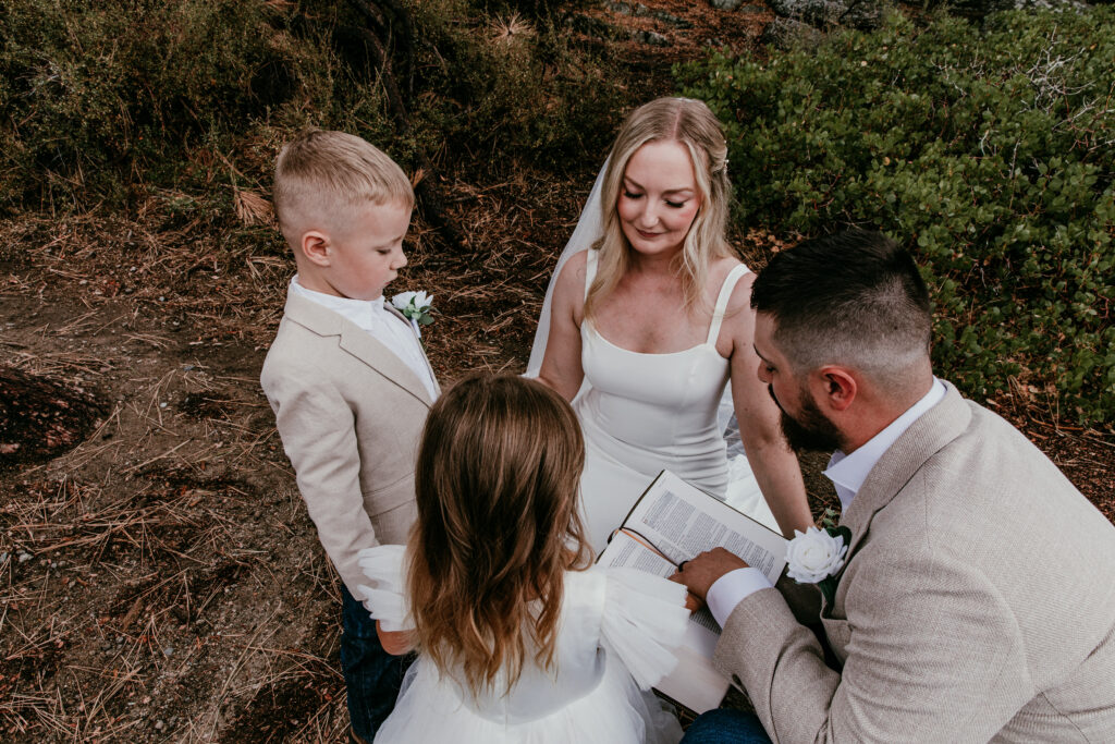 Parents and children reading scripture together during blended family elopement in Lake Tahoe