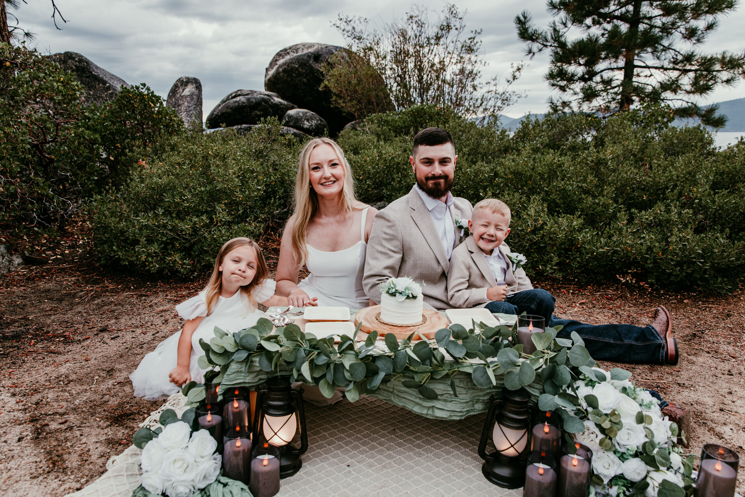 Blended family enjoying styled elopement picnic with matching faux florals at Sand Harbor
