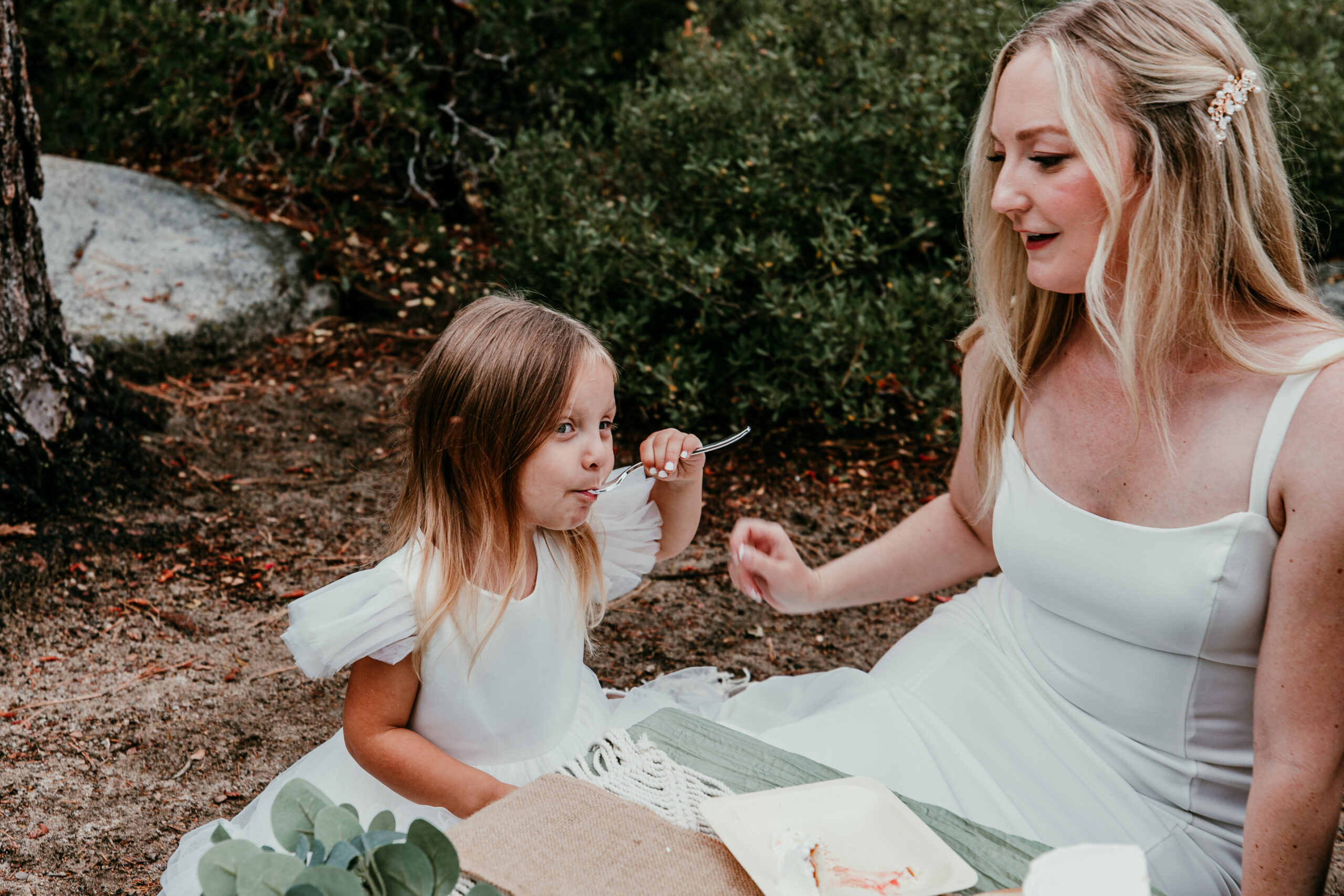Mother and step daughter sharing cake during Lake Tahoe family elopement picnic