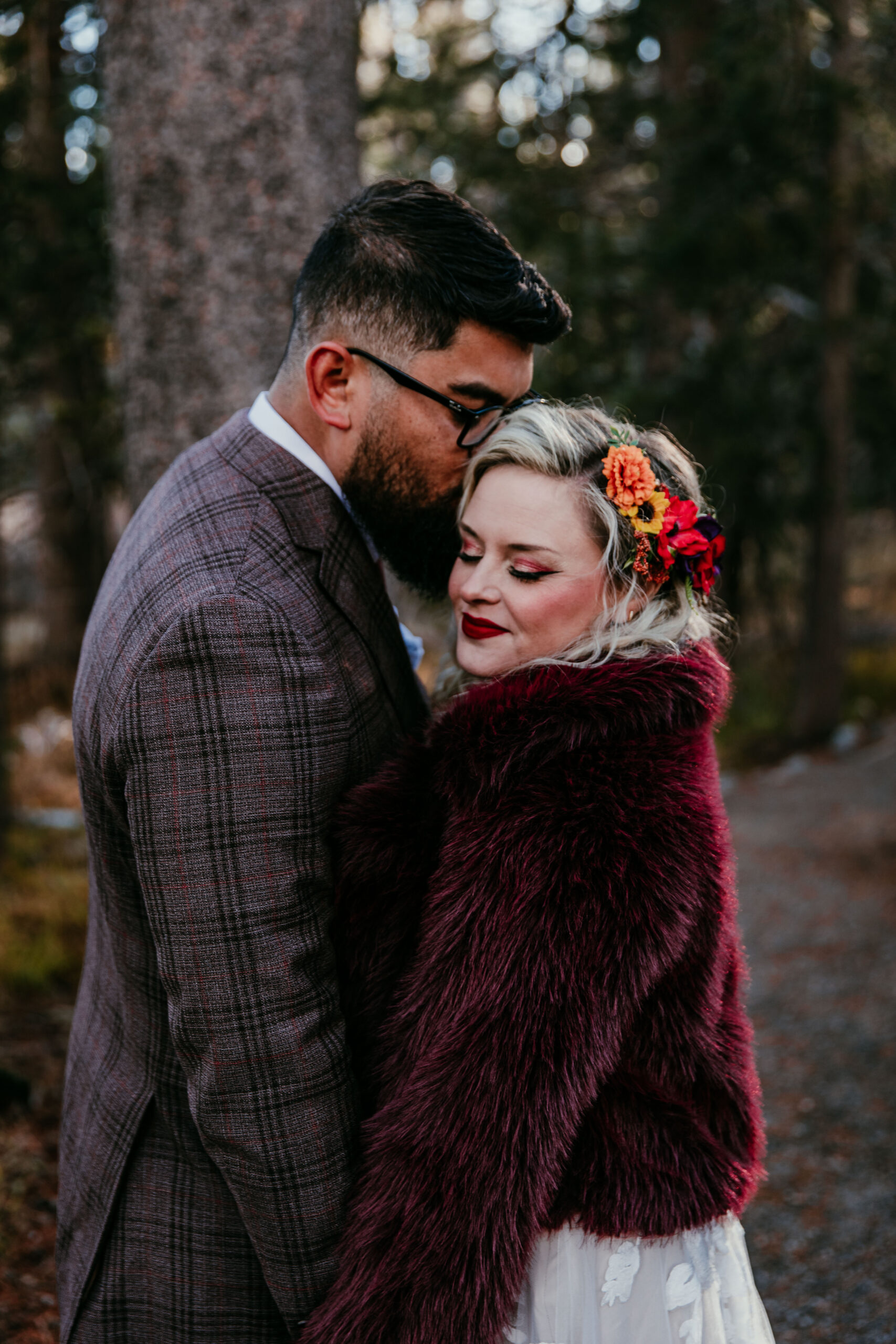 Bride wrapped in burgundy fur shawl during a snowy winter elopement portrait session in Truckee, California.