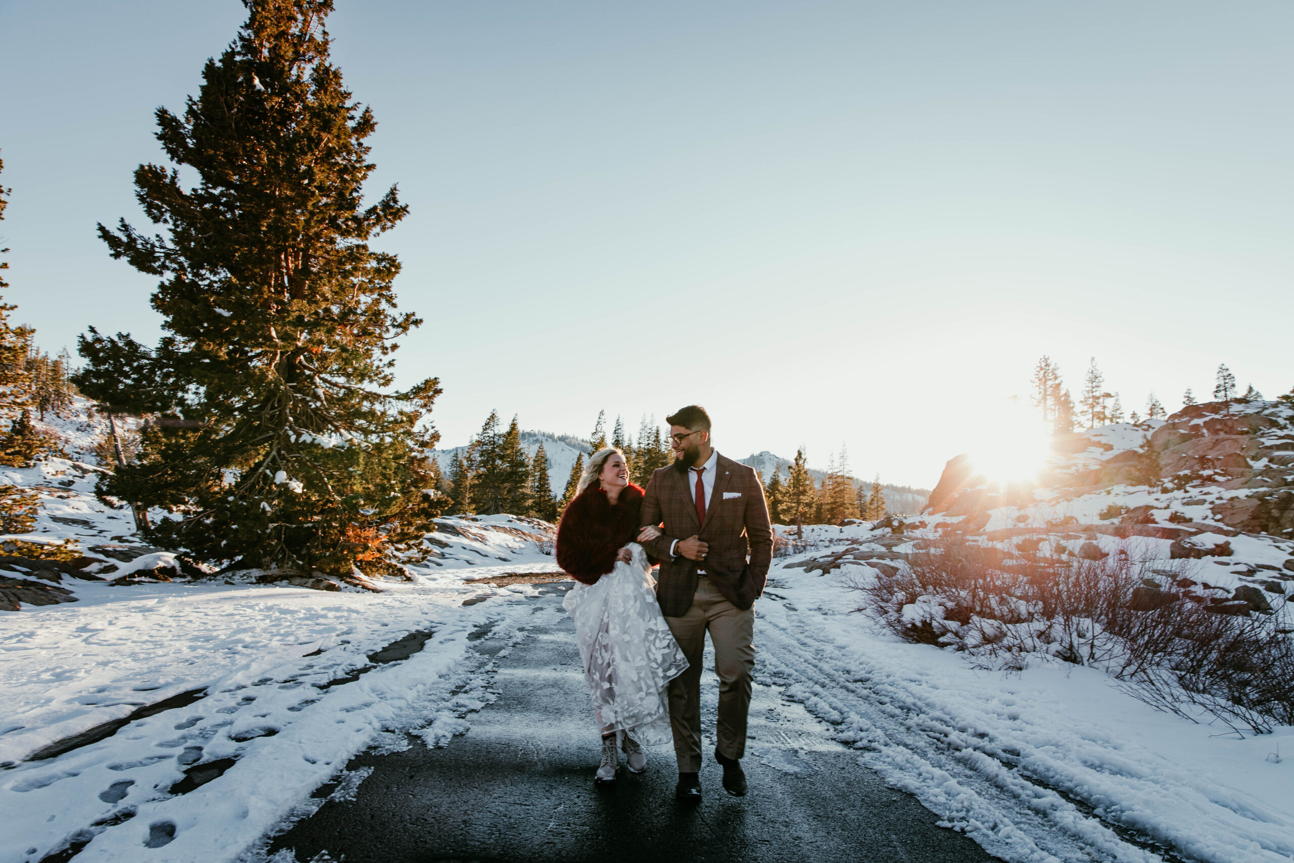 Bride and groom walking through snow at Donner Summit during their winter elopement in Truckee, California.