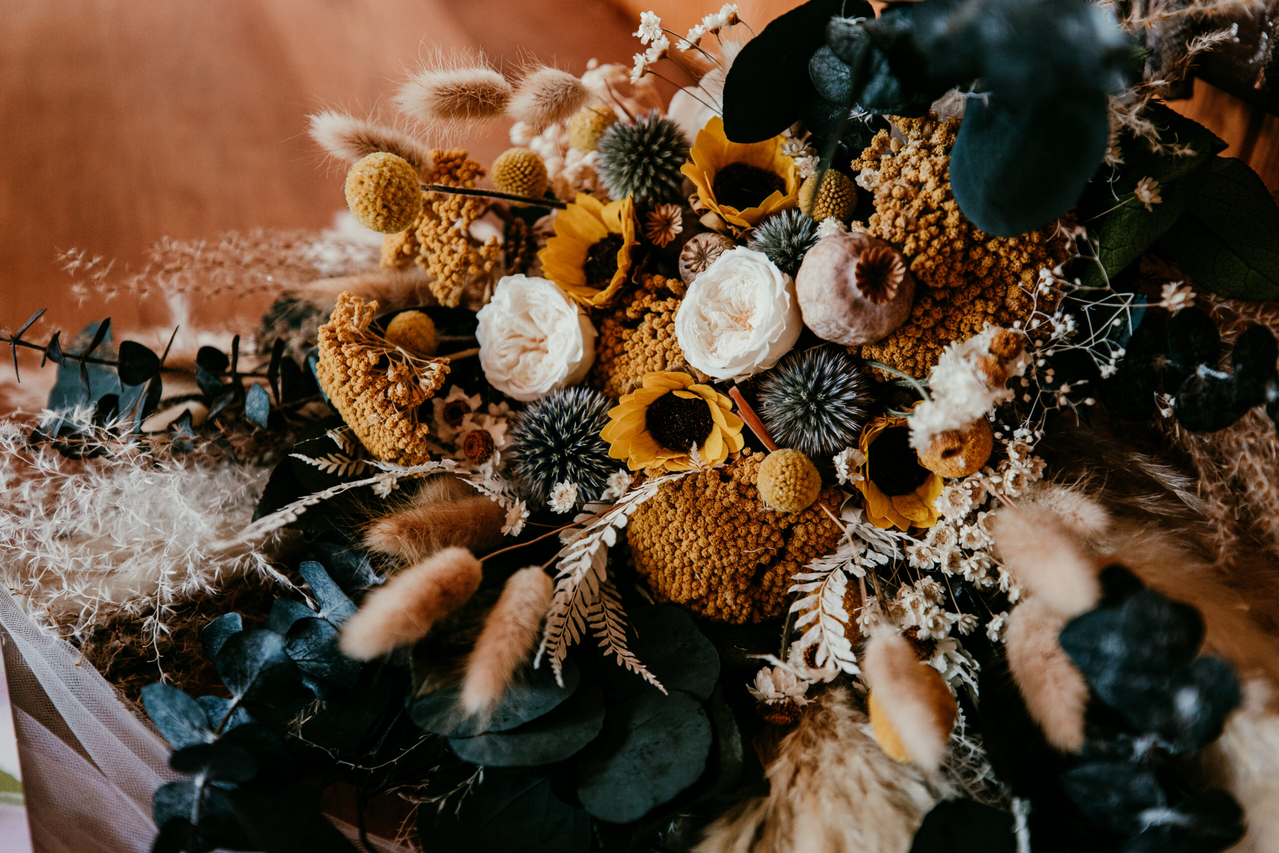 Fall-inspired faux bridal bouquet with sunflowers, textured florals, and warm autumn tones.