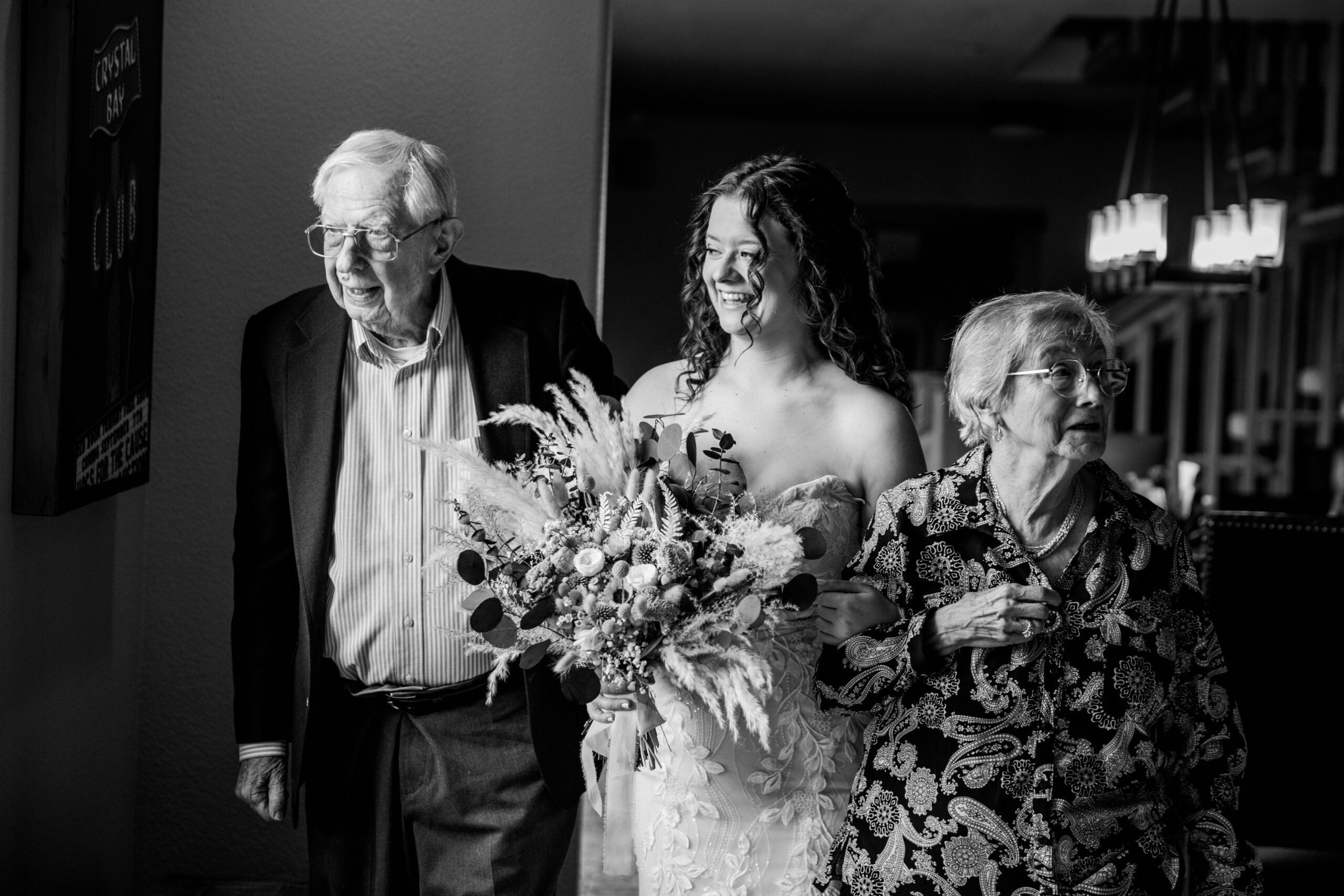 Bride walking with her grandparents inside the Lake Tahoe Airbnb before her intimate elopement ceremony.