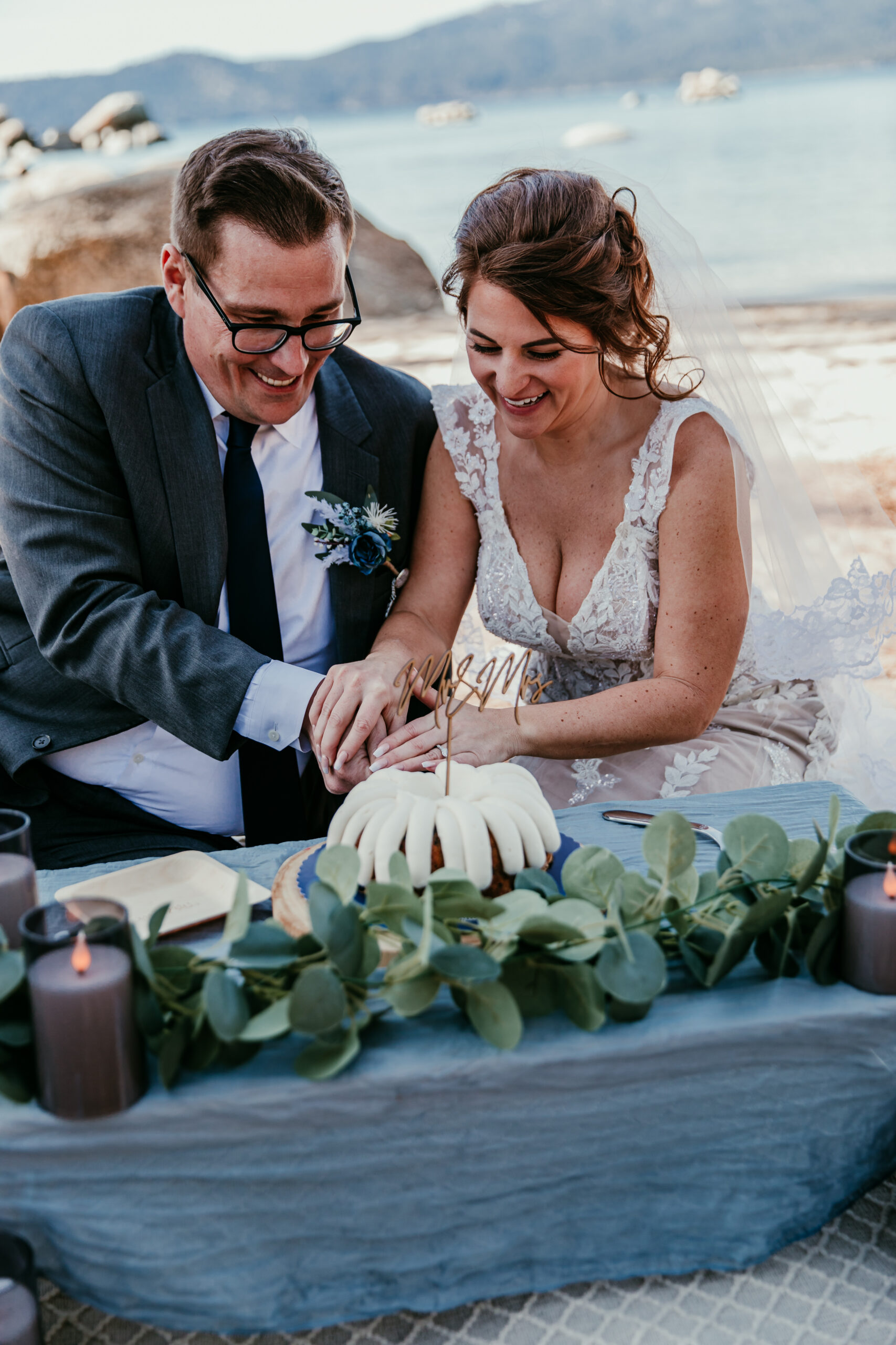Why elope instead of having a wedding – couple cutting small wedding cake during intimate Lake Tahoe elopement picnic