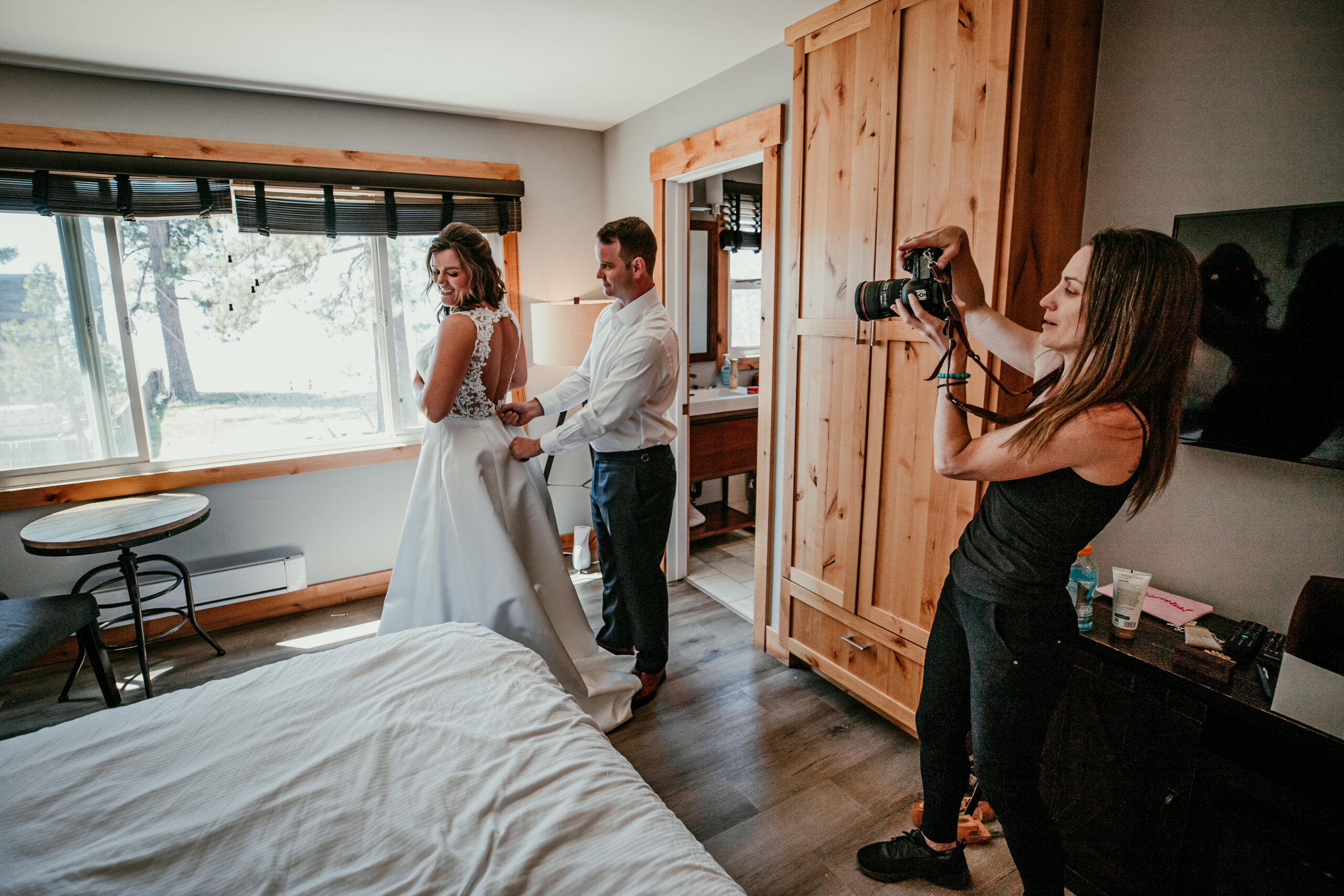 Elopement photographer capturing candid getting-ready moments as a bride and groom prepare for their intimate wedding day.
