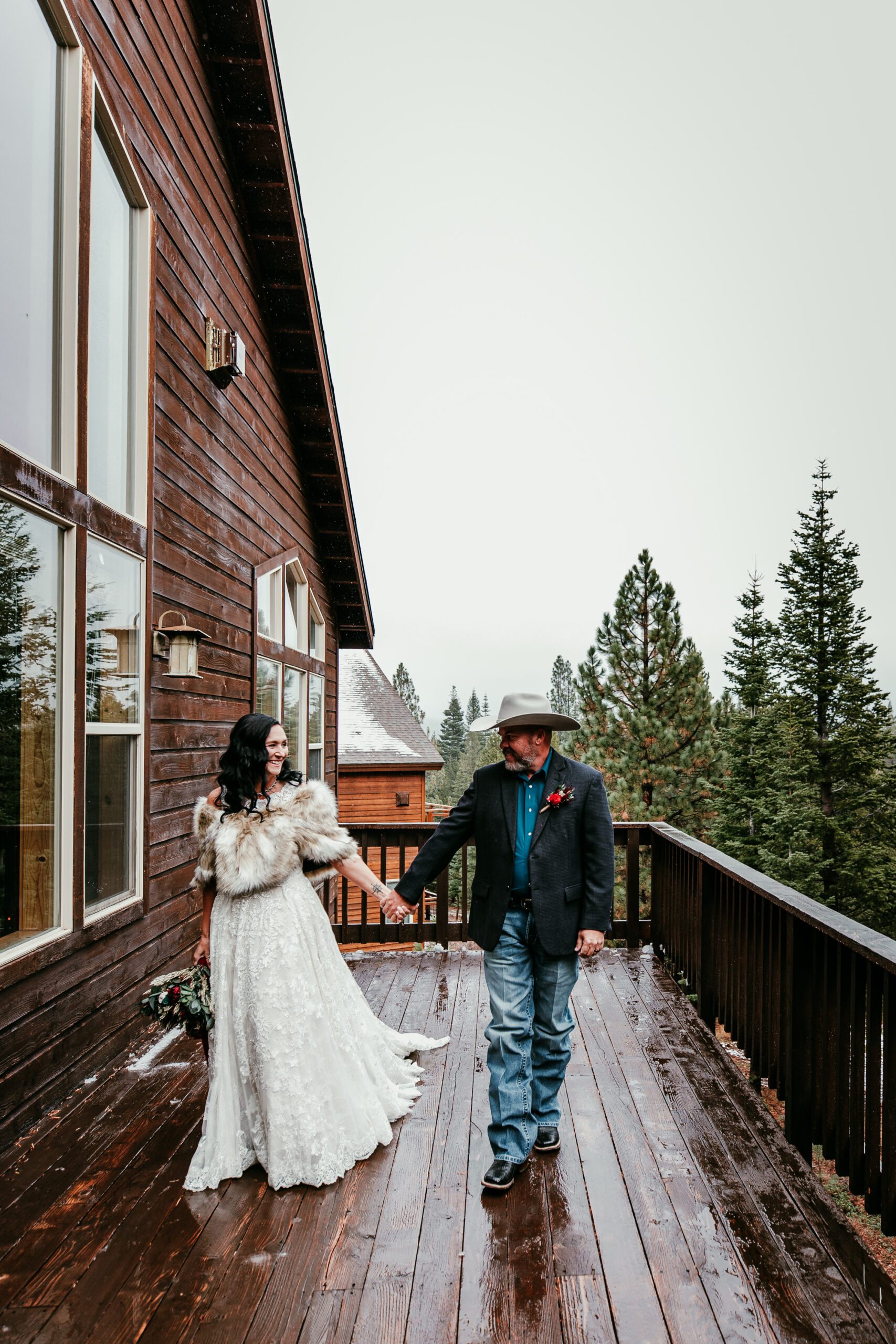 Couple walking on a mountain cabin deck surrounded by forest views, highlighting peaceful elopement ideas in California