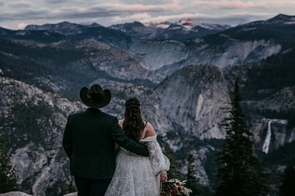 Couple overlooking Yosemite Valley during their destination elopement in Yosemite National Park.