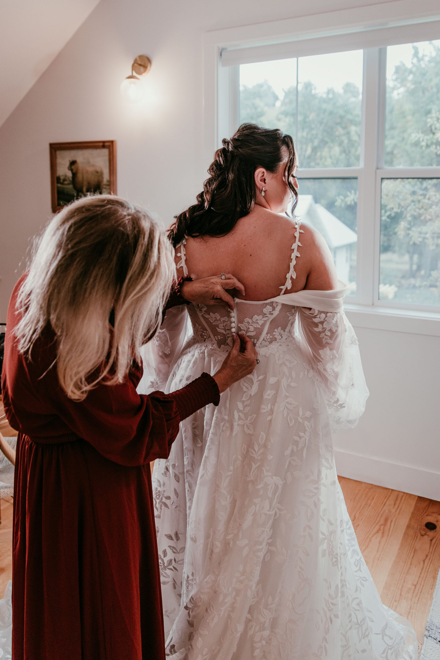 bride getting her wedding dress zipped while getting ready for a fall elopement in Yosemite