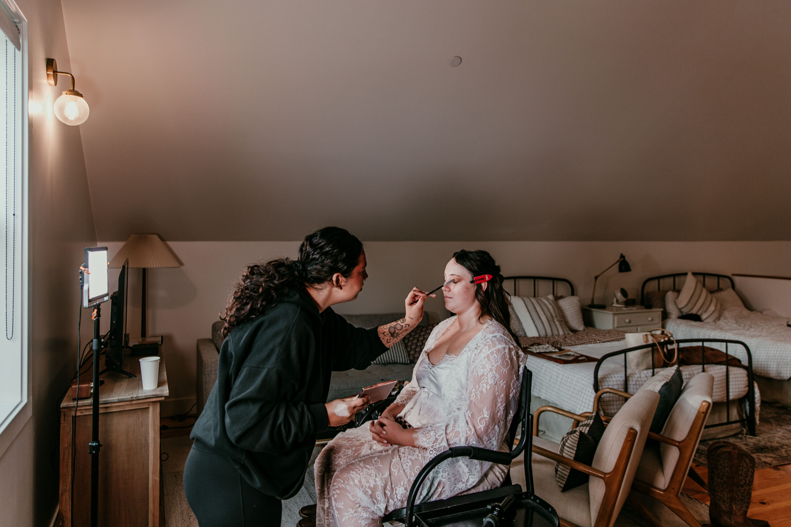 bride getting makeup done before her fall elopement in Yosemite